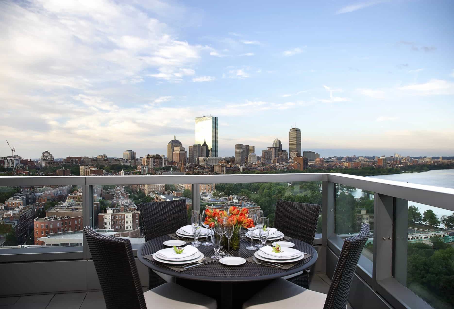rooftop terrace with a dining table and city view