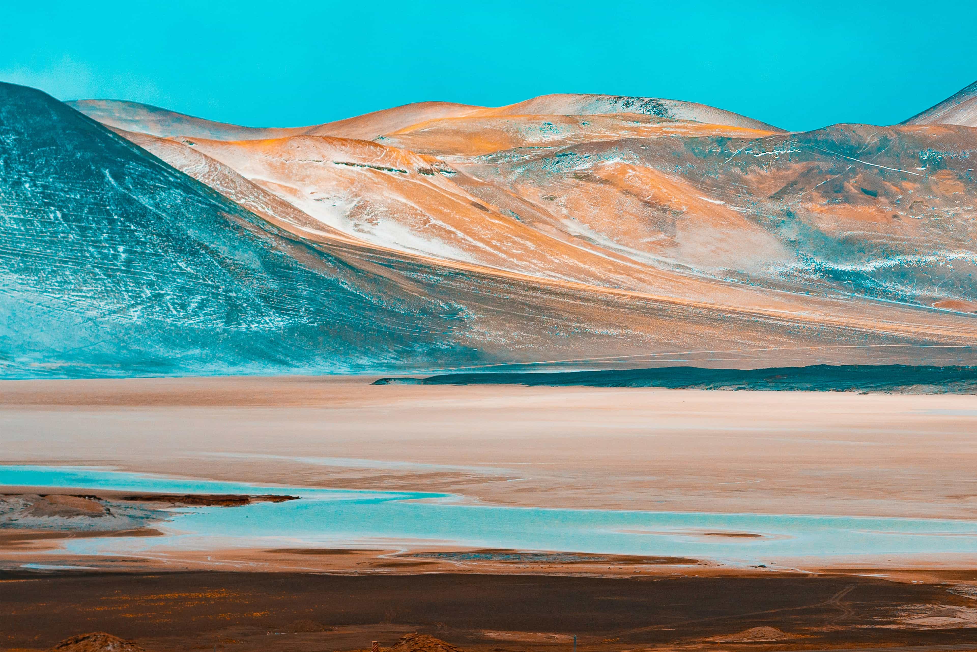 brown and gray mountains near body of water during daytime