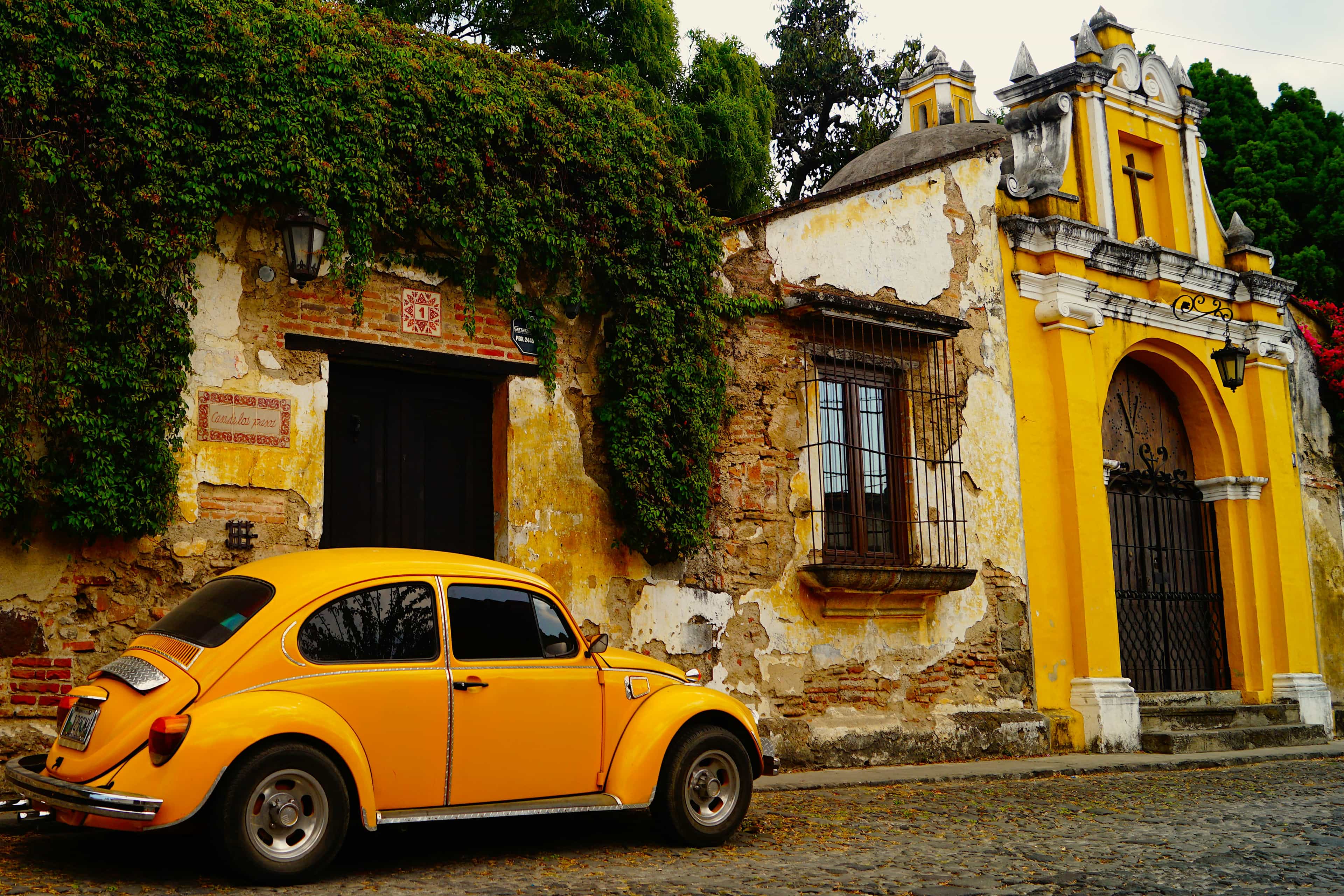 a yellow car parked in front of a building