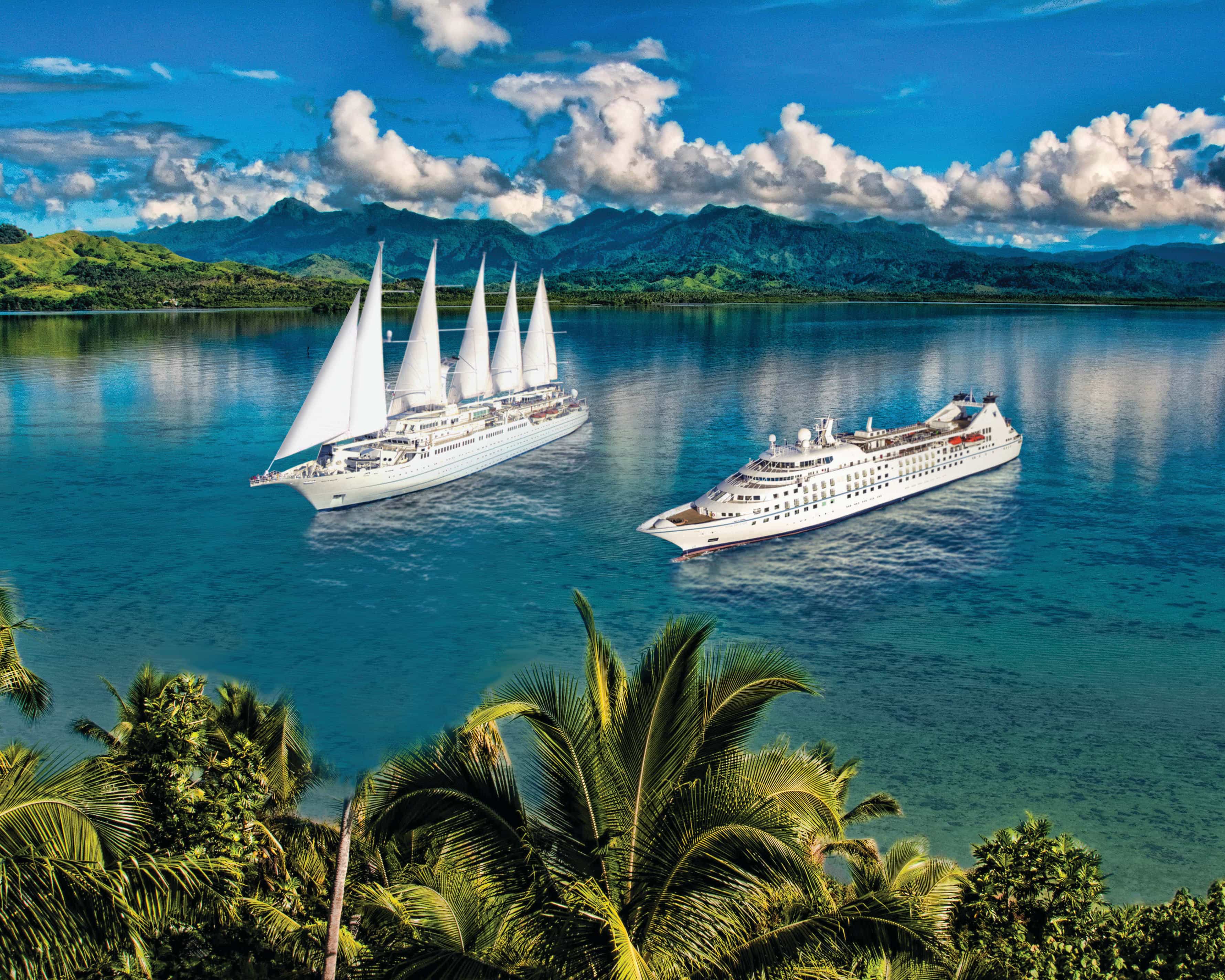 a small modern cruise ship and white sail cruise ship in turquoise waters surrounded by palm trees and green tropical island during day