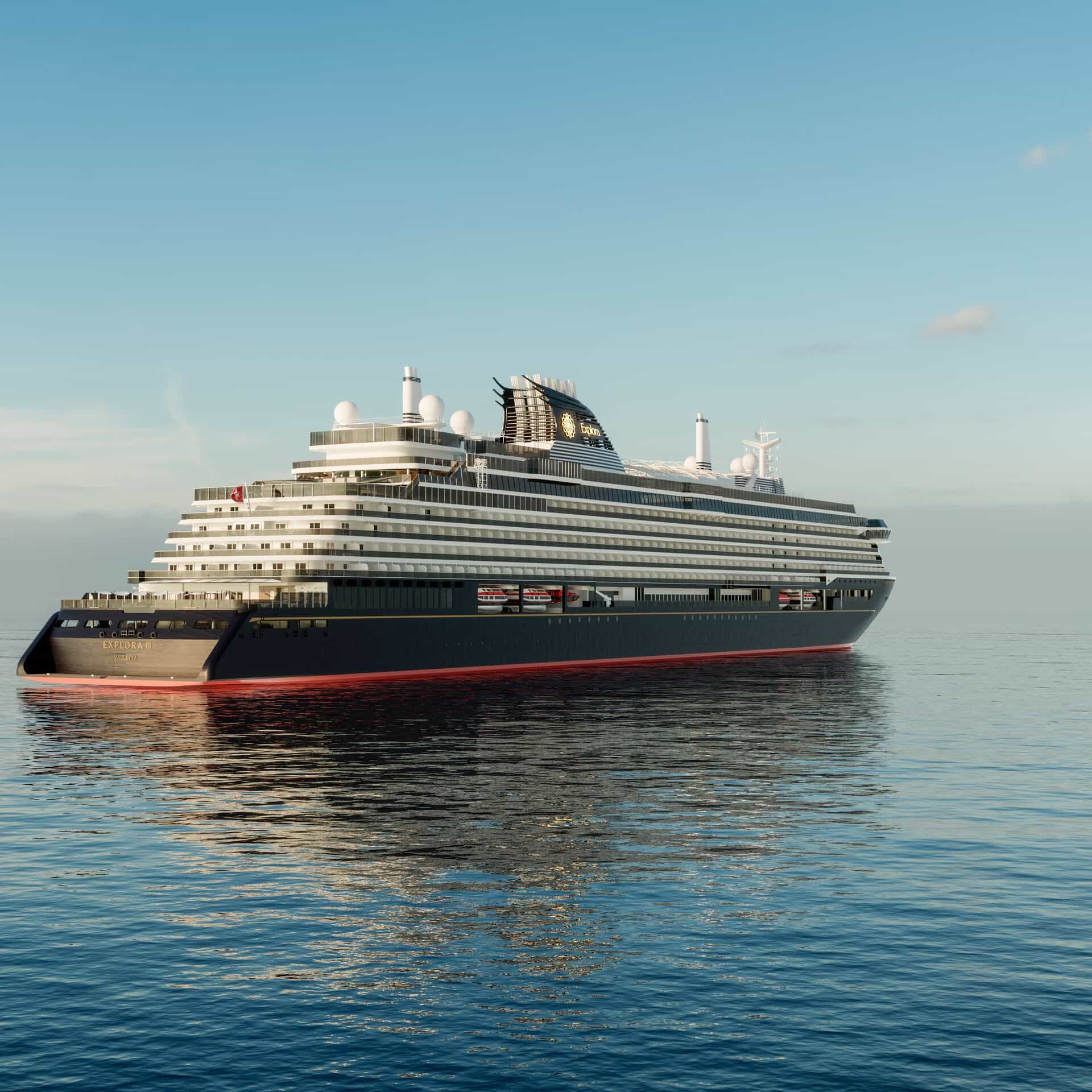 A sleek, modern luxury cruise ship sailing on calm open water, shown in profile with tiered decks, glass-fronted balconies, and a dark navy hull under a clear blue sky.