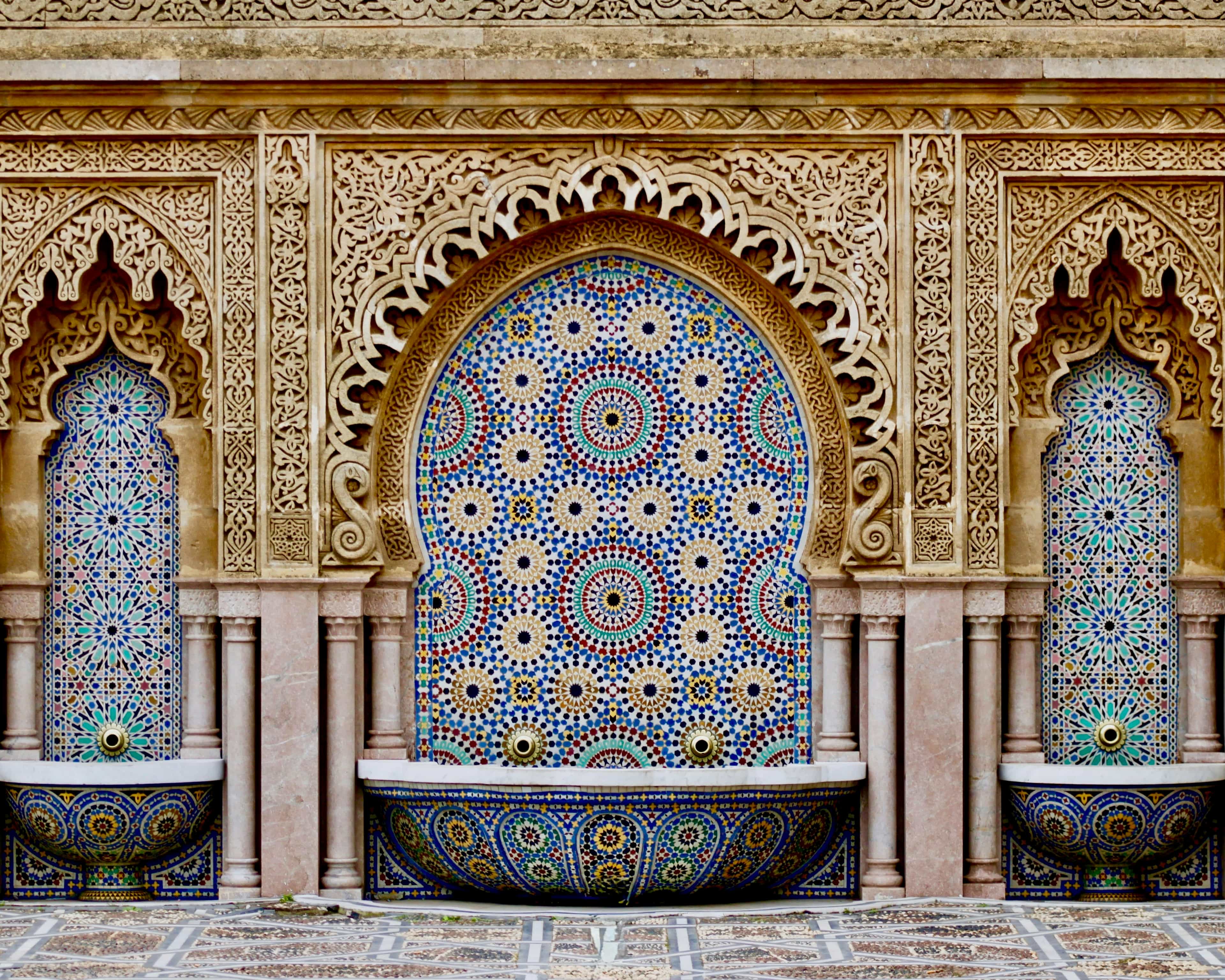 intricate tile wall with fountains in a courtyard