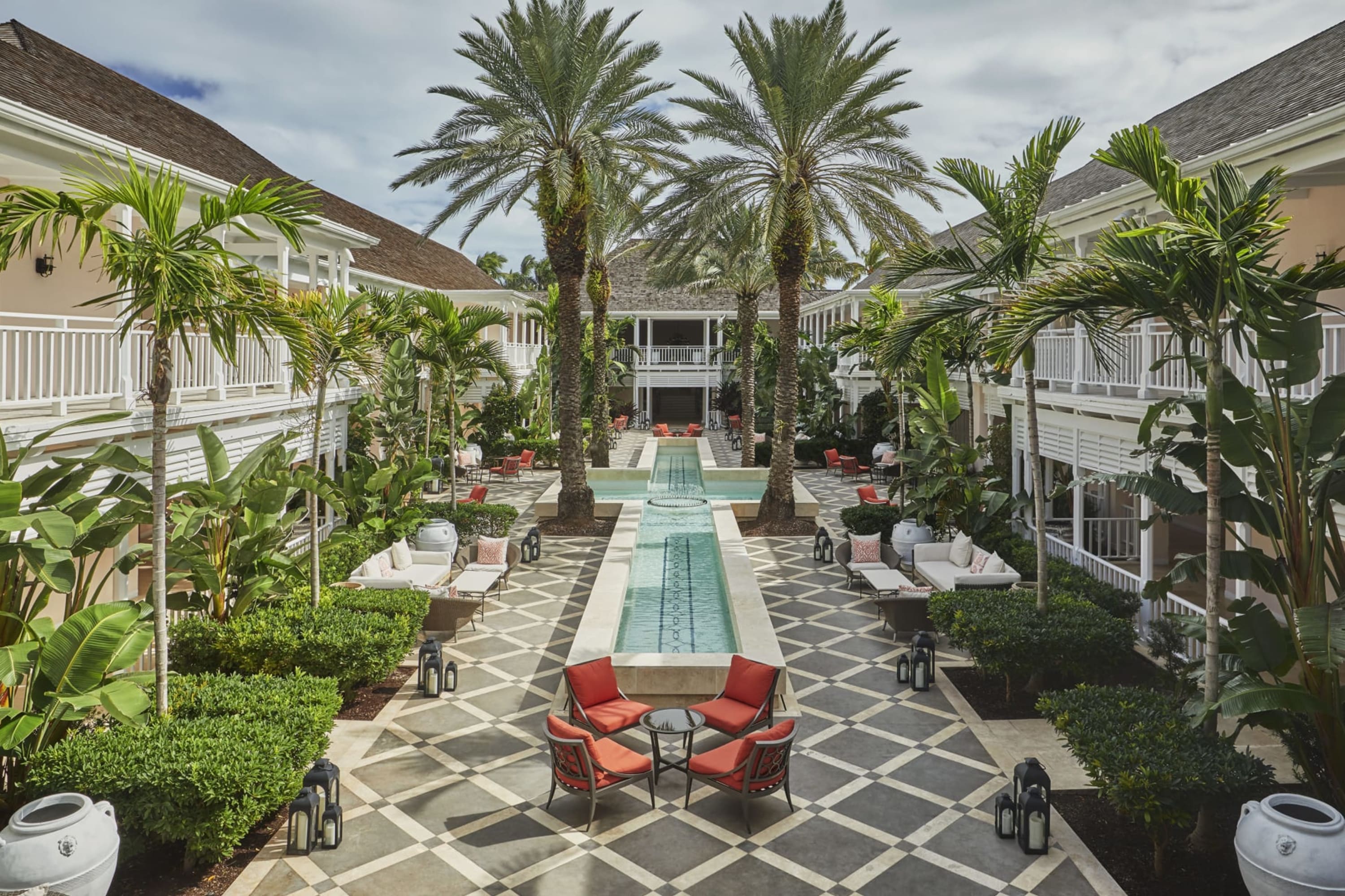 Ritzy and well-manicured resort grounds with water features, gardens and chic, beach architecture