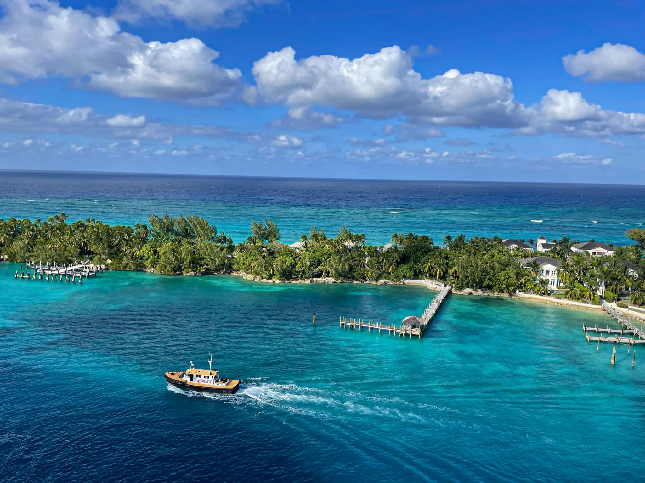 A high view of the ocean on a clear day with and island in the distance on a sunny day.