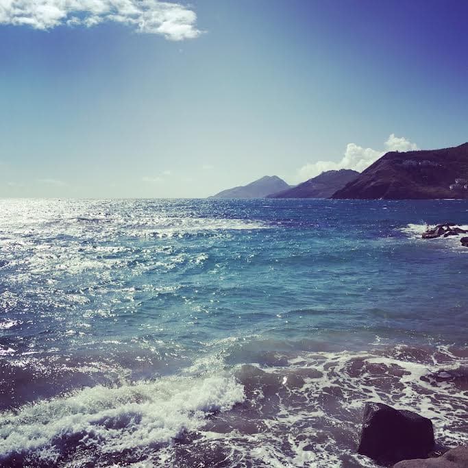 A beautiful view of the ocean with soft waves on a sunny day