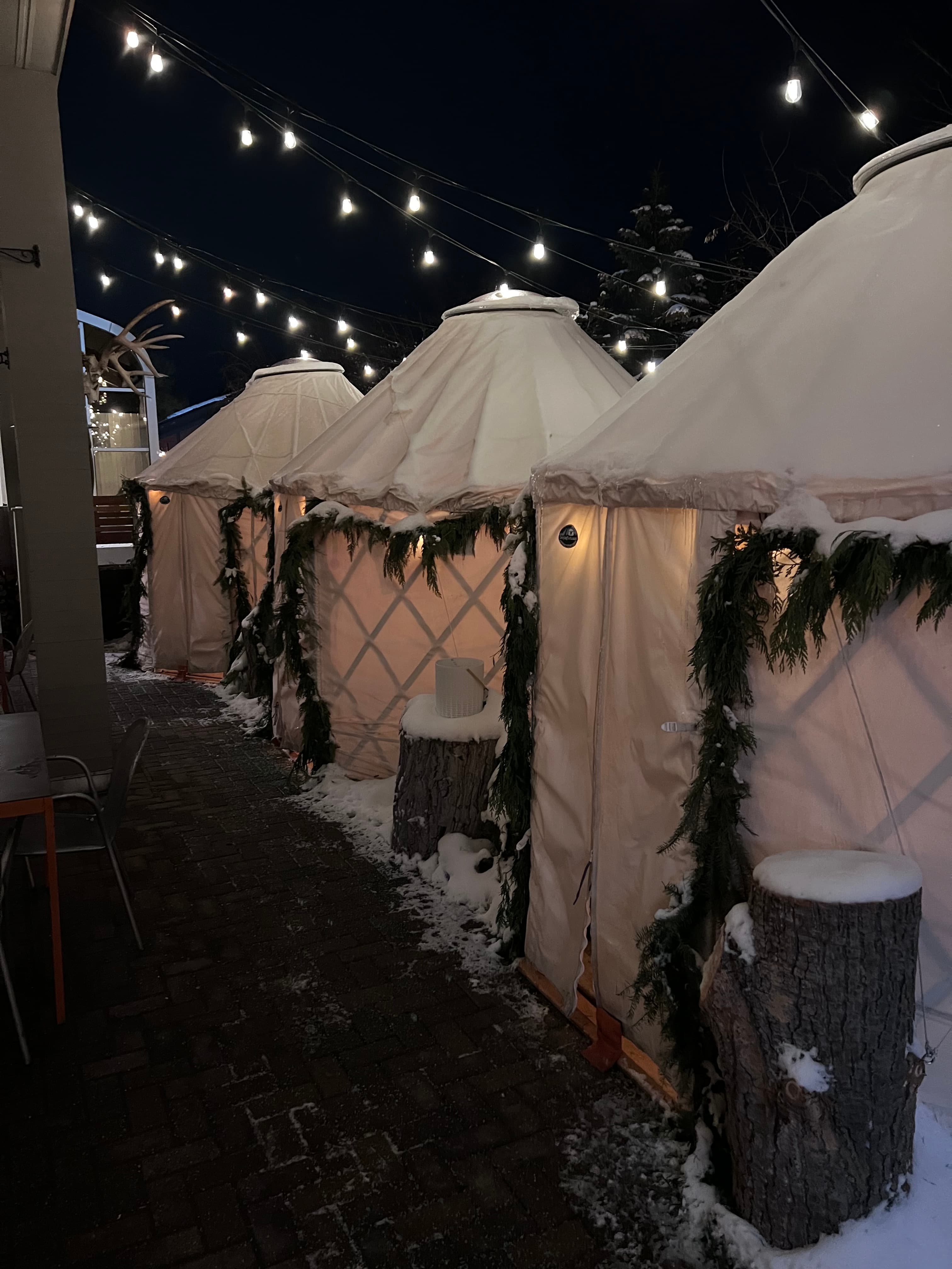 An image of outside huts with lights.