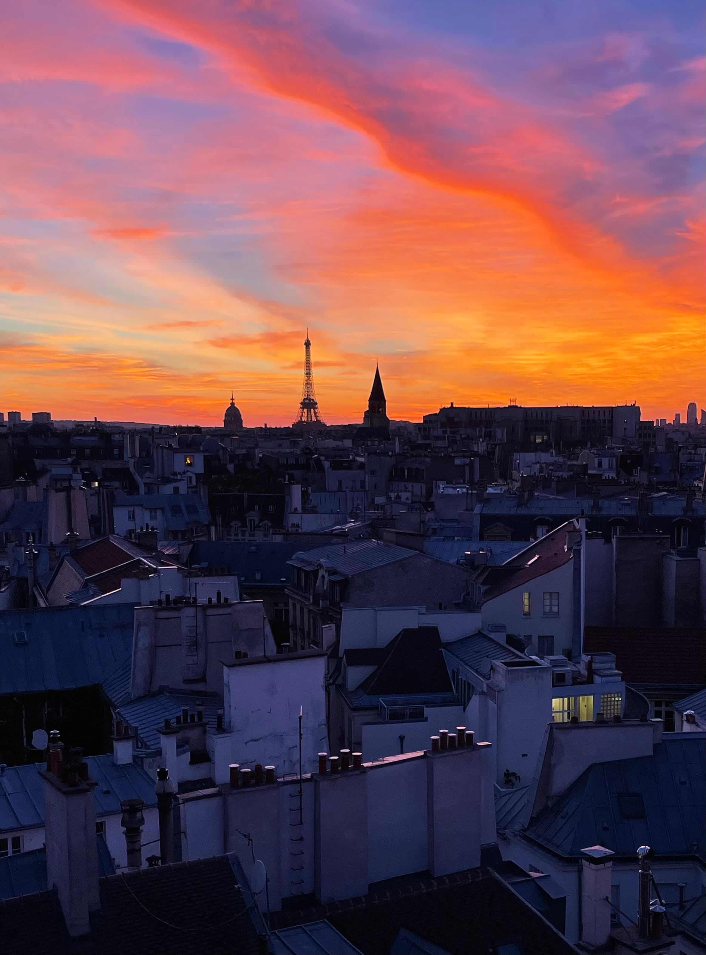 View of a beautiful bright orange sunset over the Paris skyline