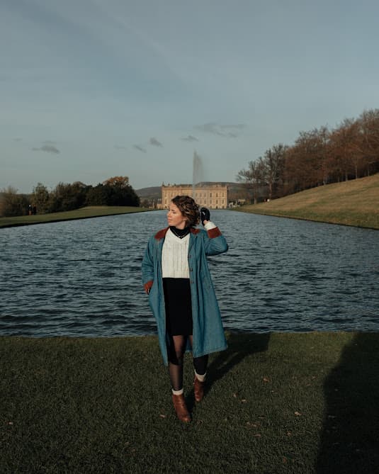 Advisor posing for an image with a body of water in the distance.