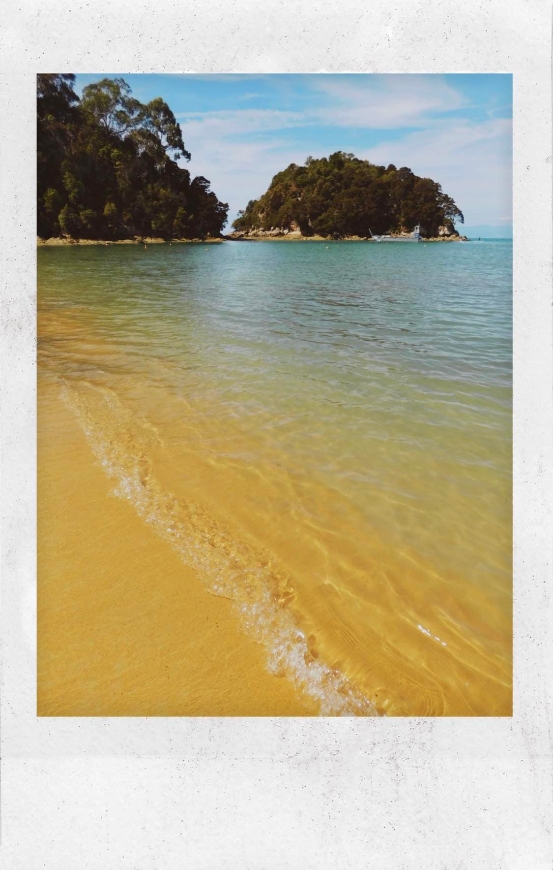 Polaroid picture of the beach during the daytime.