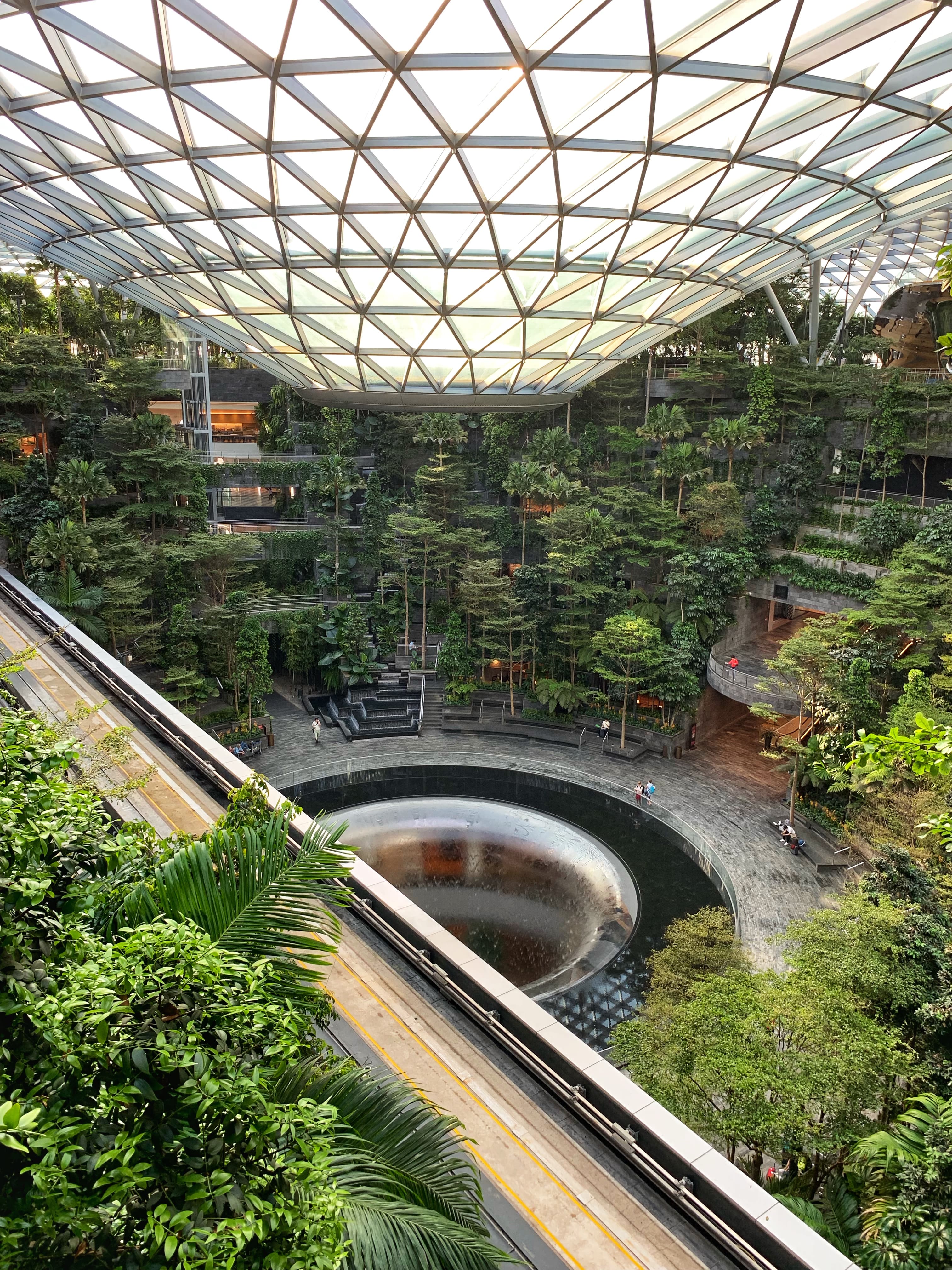 View of the green atrium at Singapore airport where the waterfall emerges from the ceiling