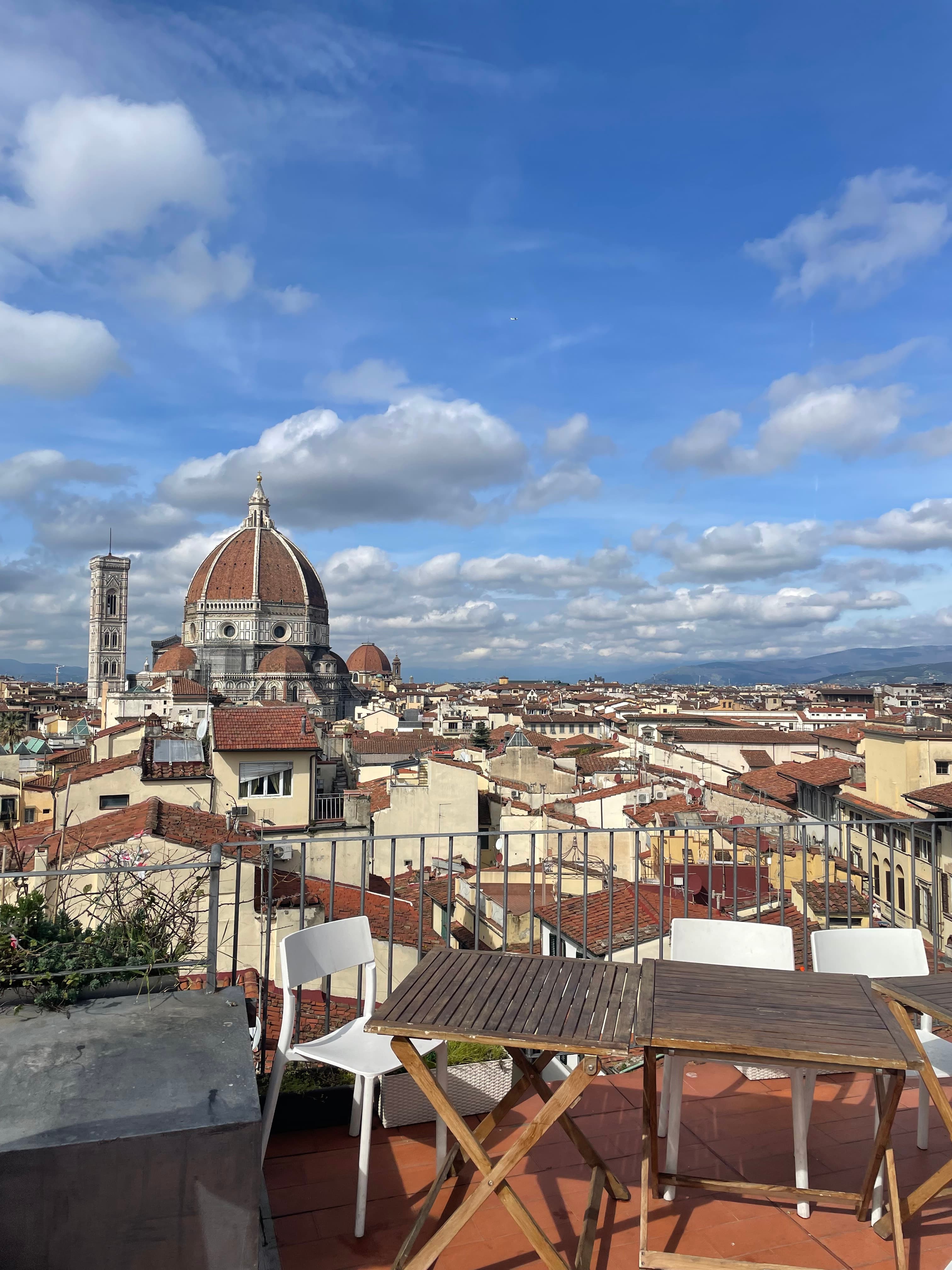 Beautiful rooftop view of the Florence duomo and surrounding rooftops on a sunny day