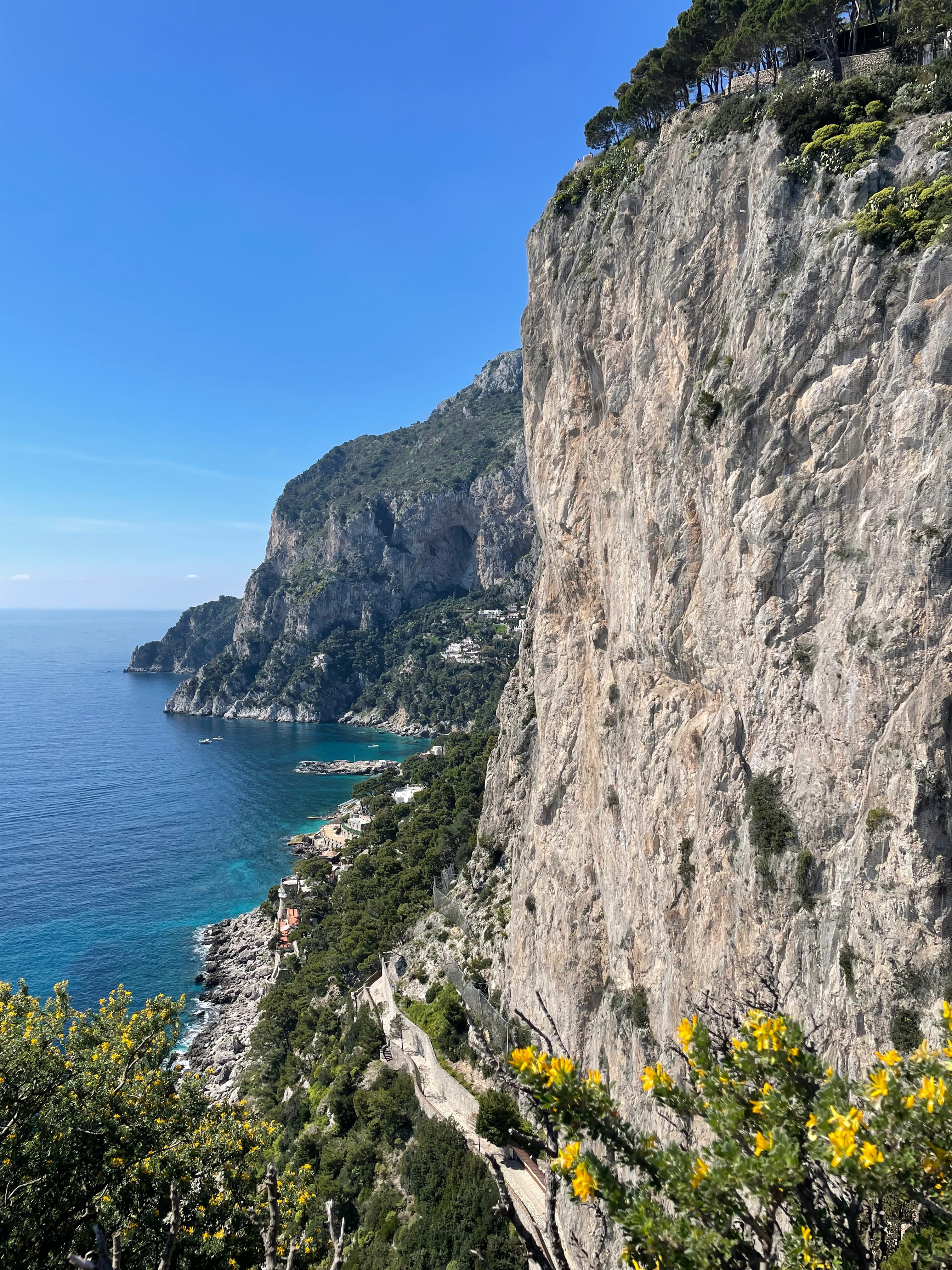 Beautiful view of the sea and coast lined with steep rocky cliffs on a sunny day