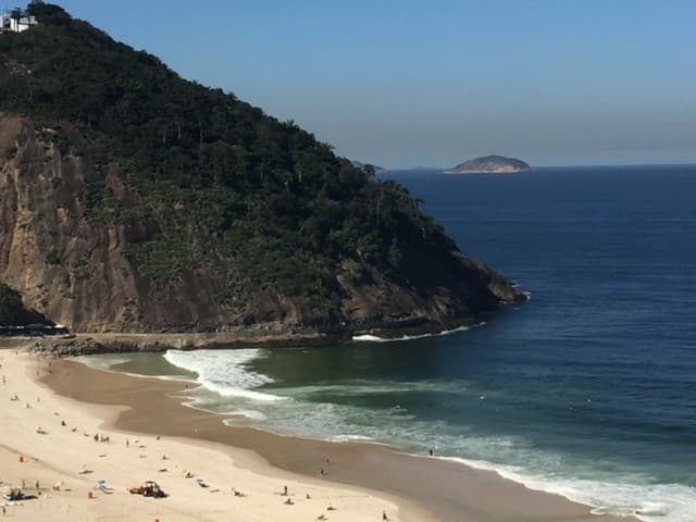 View of a beautiful empty beach and dramatic cliffs on a sunny day