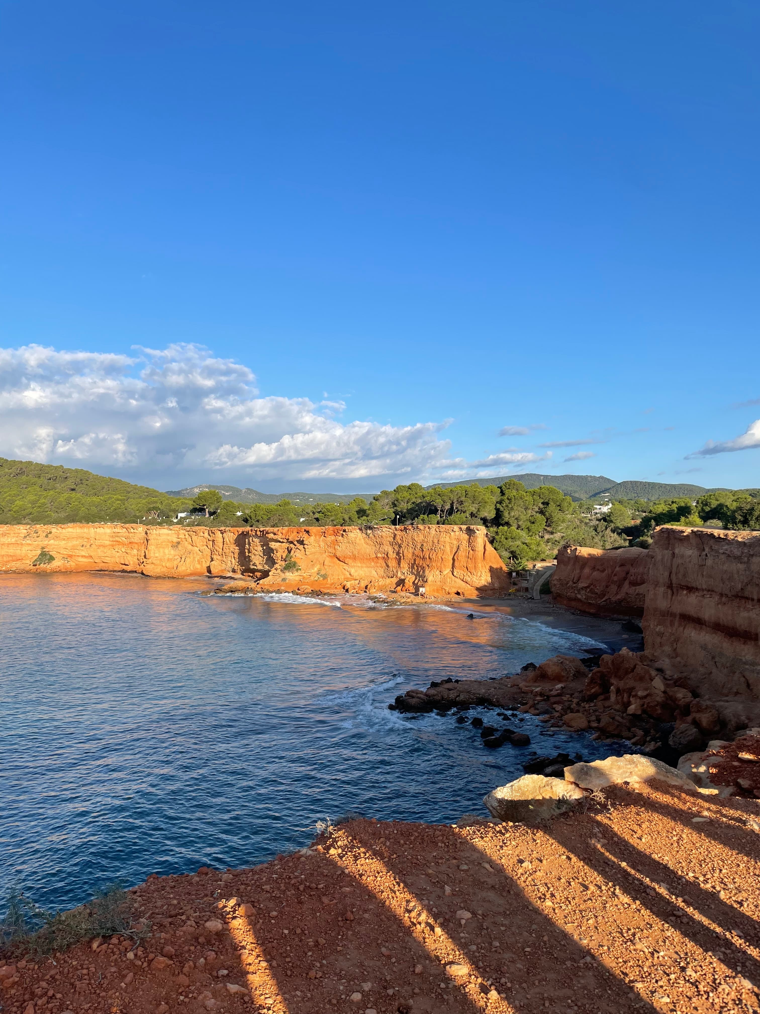 View of a lake surrounded by mountains during the daytime.