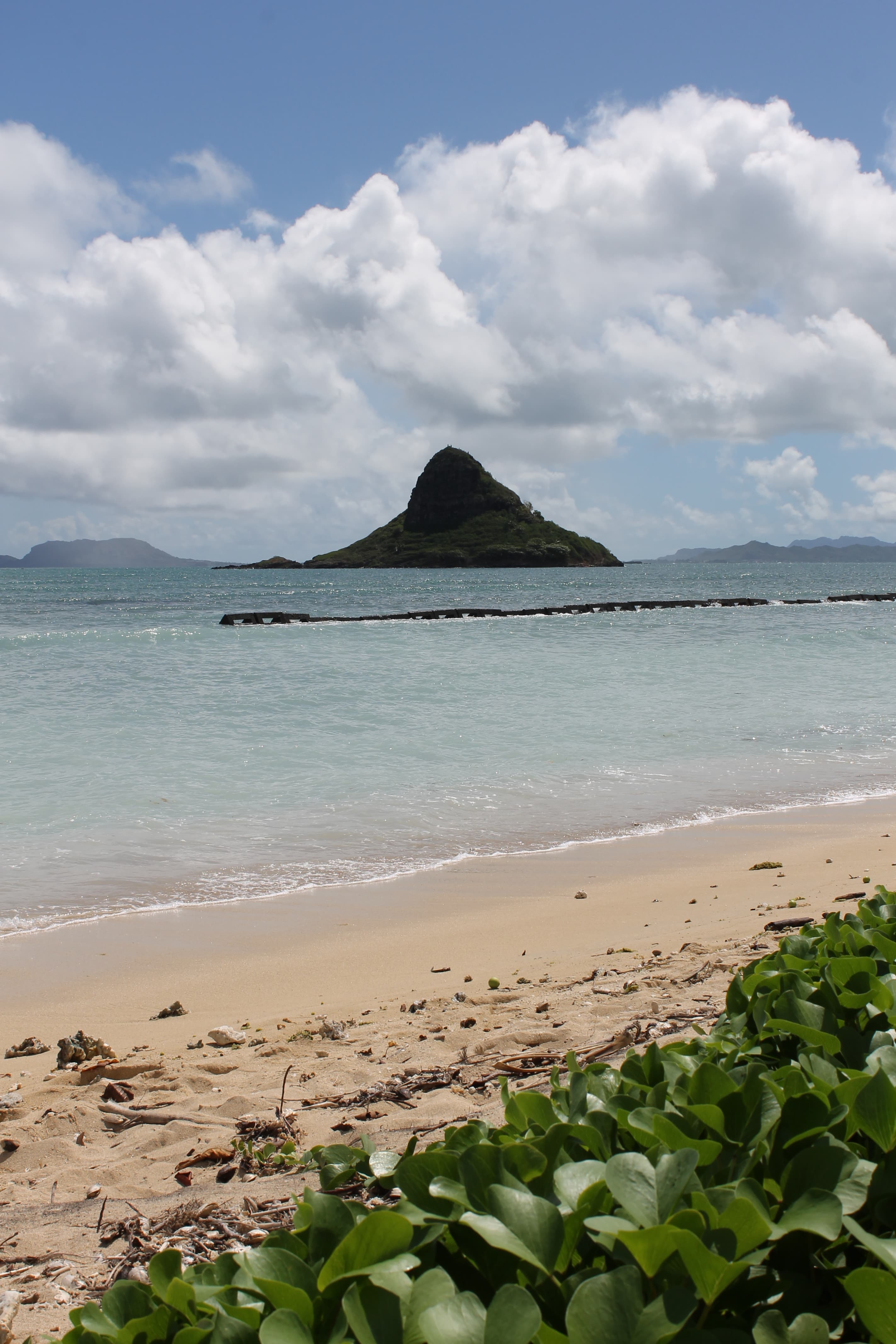 A beach with clouds in the distance.