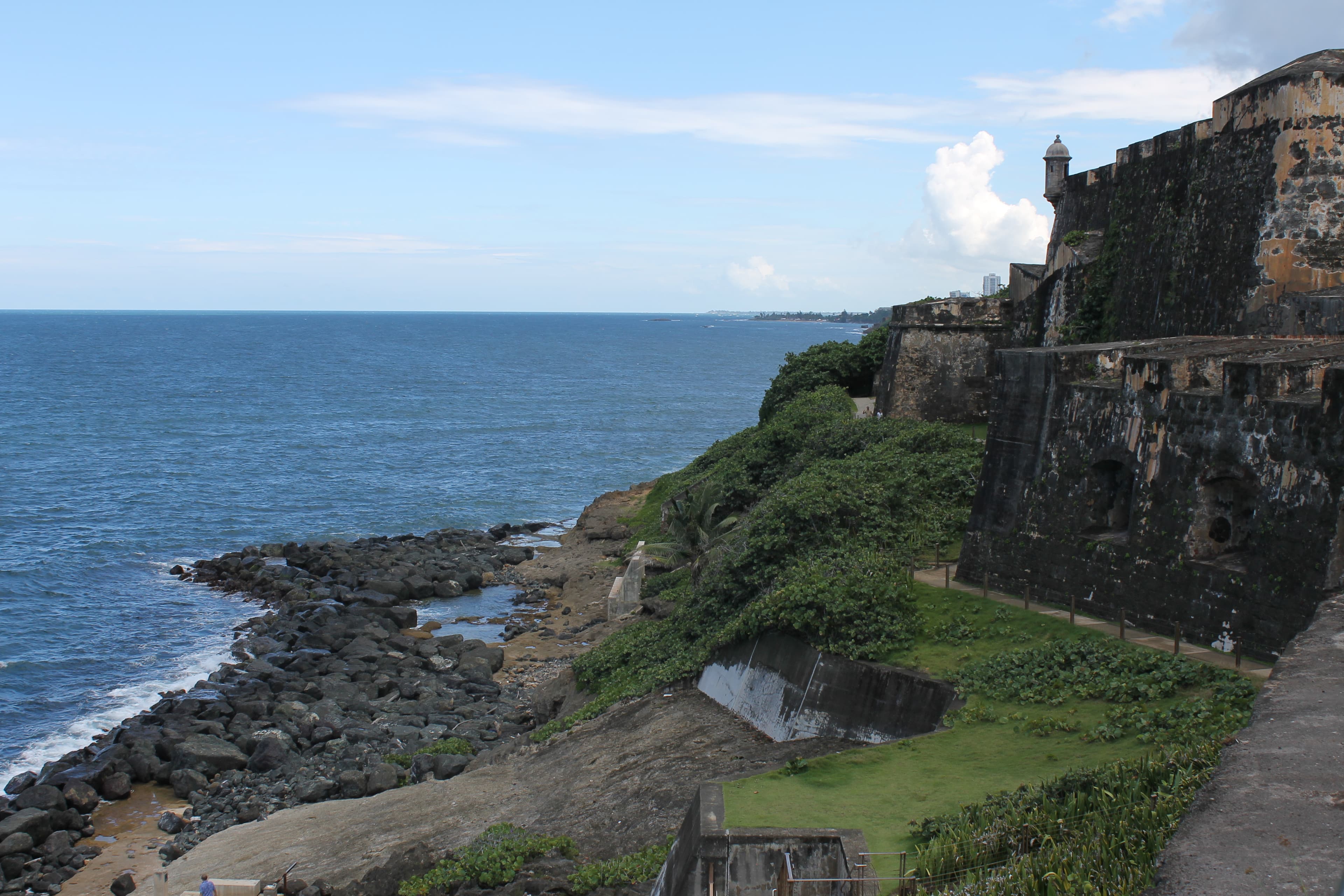 Castle walls on a rocky ocean shore.