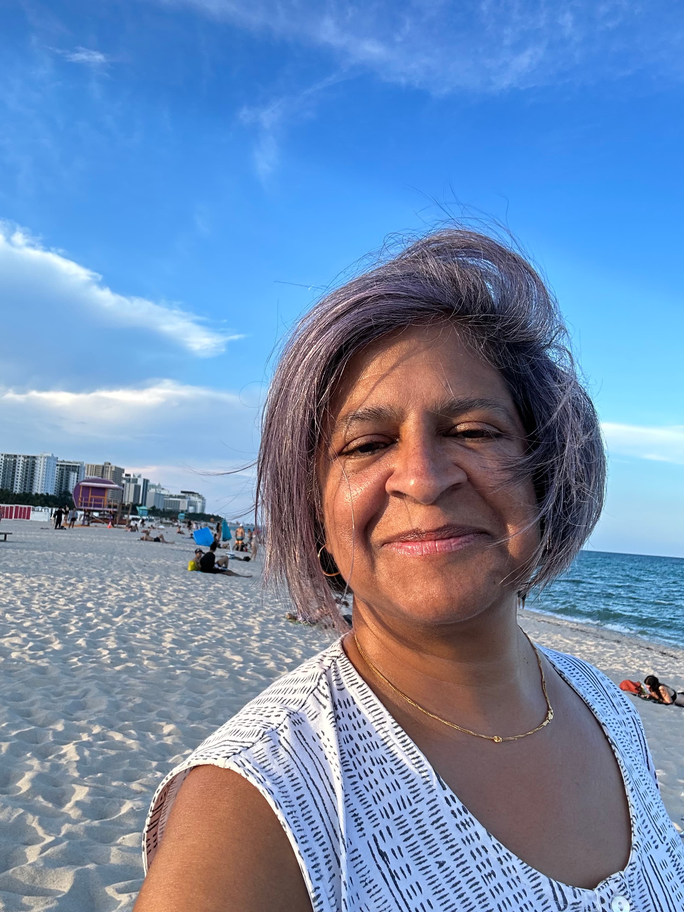 Advisor posing on a beach on a sunny day.