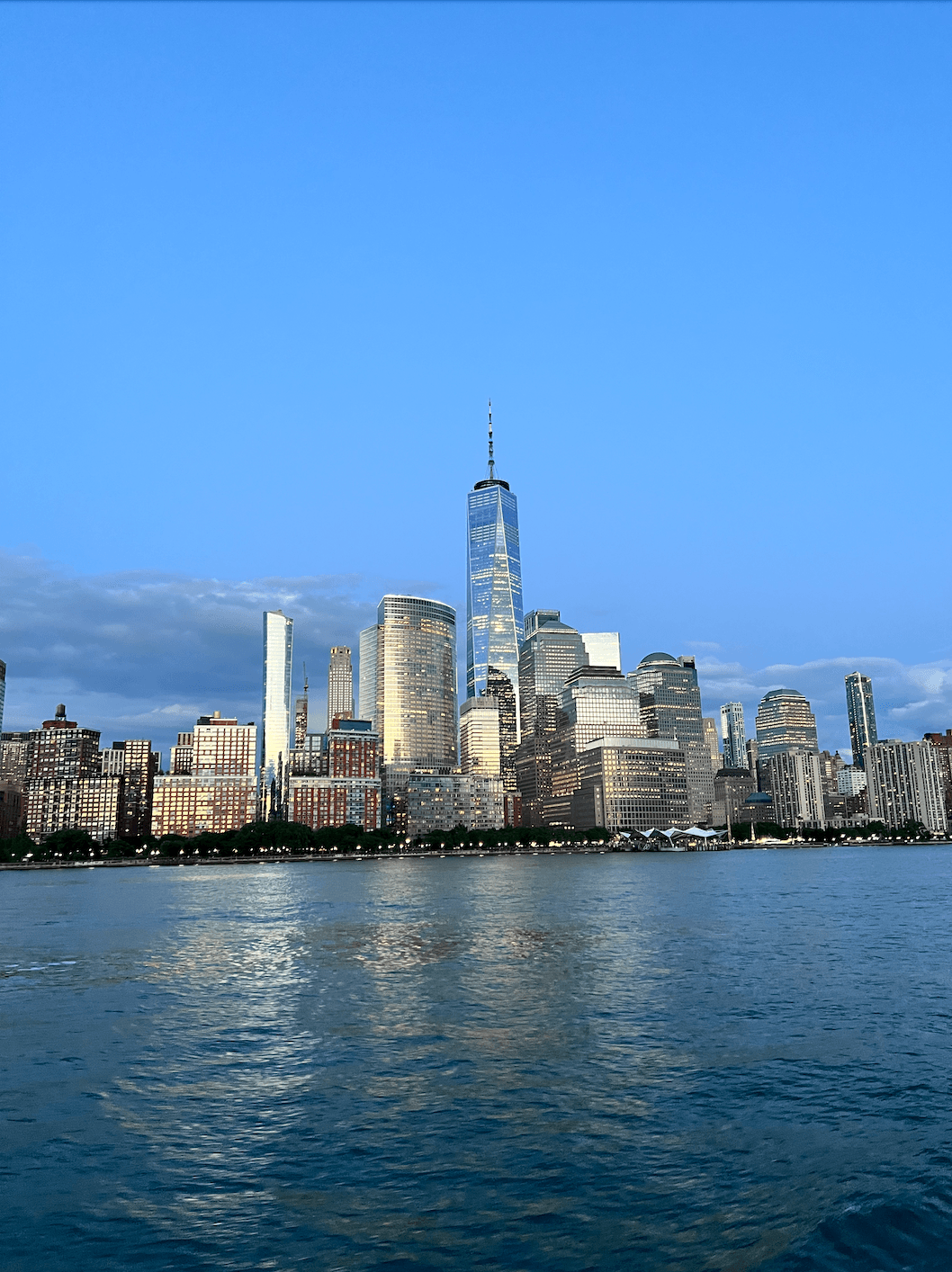 Skyscrapers by the water at dusk.