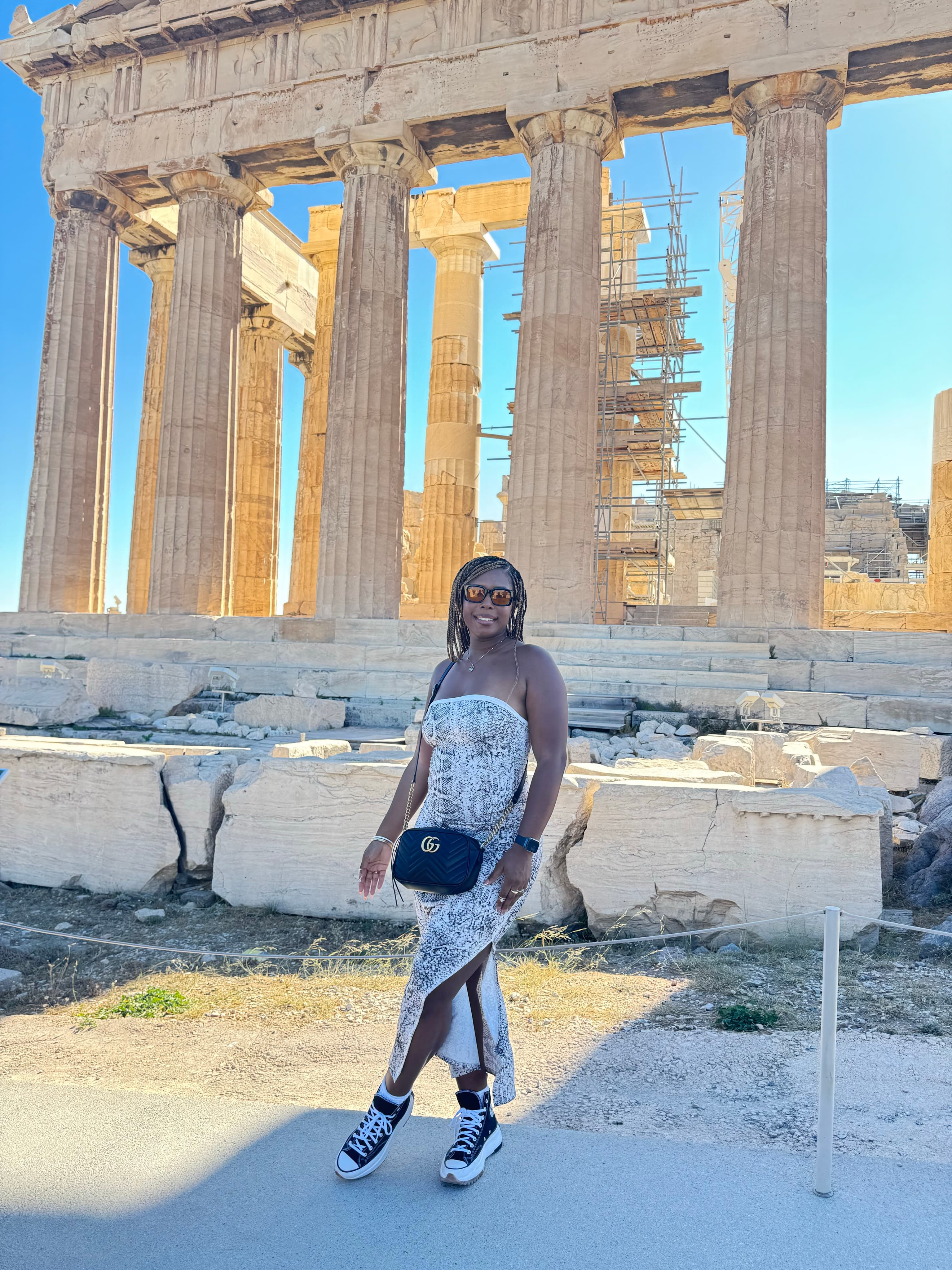 Advisor posing for an image with ruins in the distance.