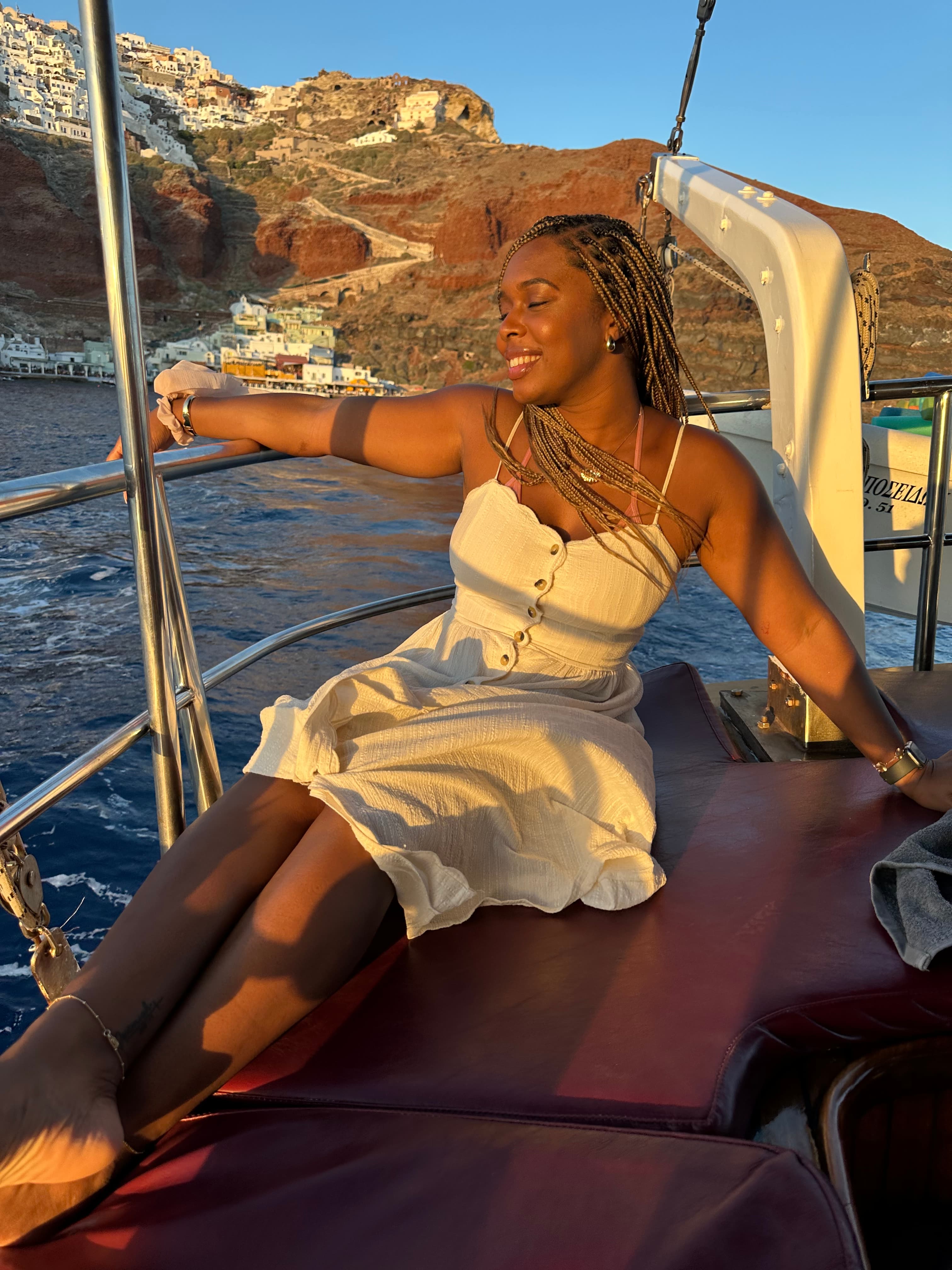 Advisor posing for an image on a boat at dusk.