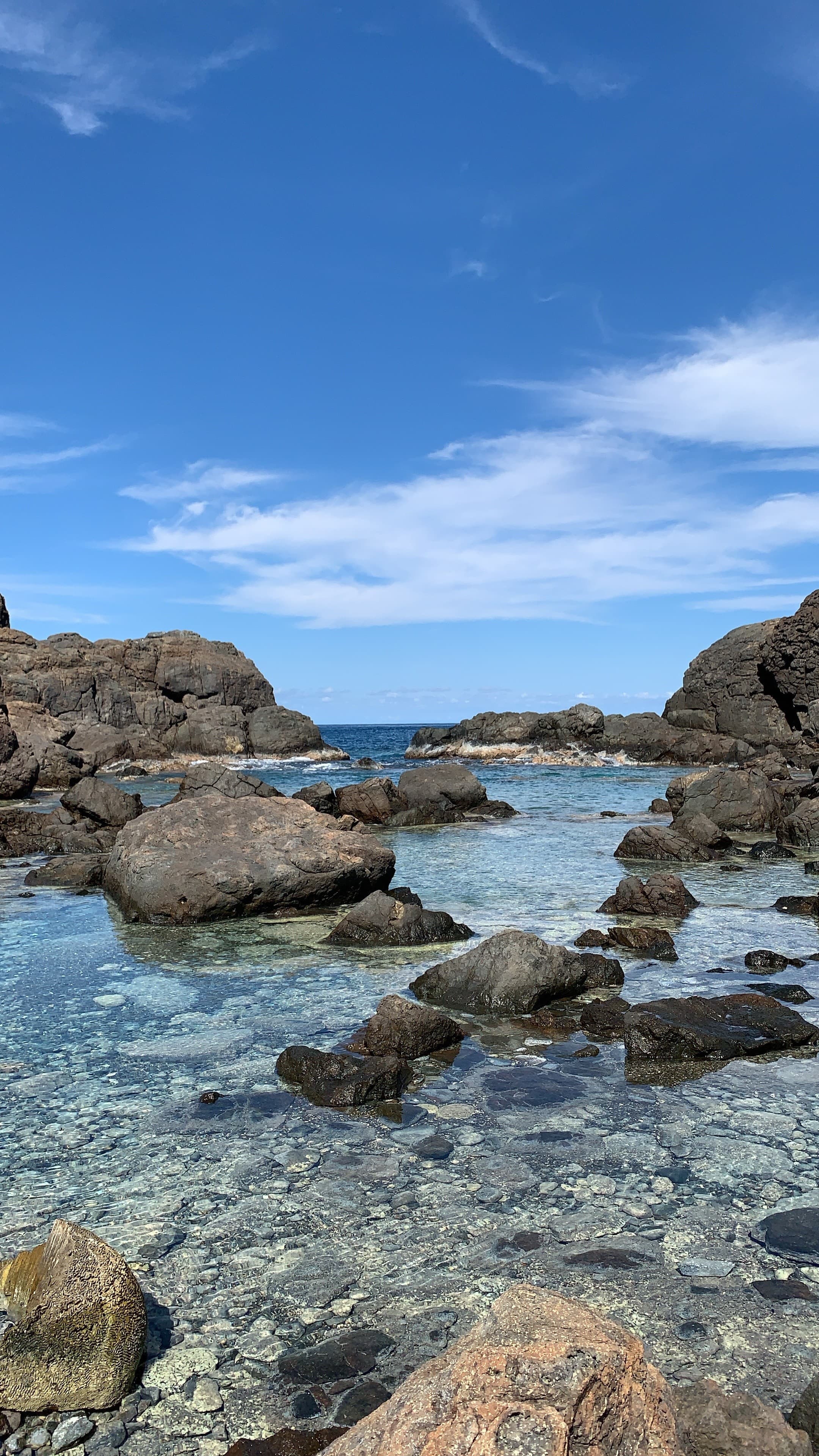 View of tide pools and rocks on a sunny day