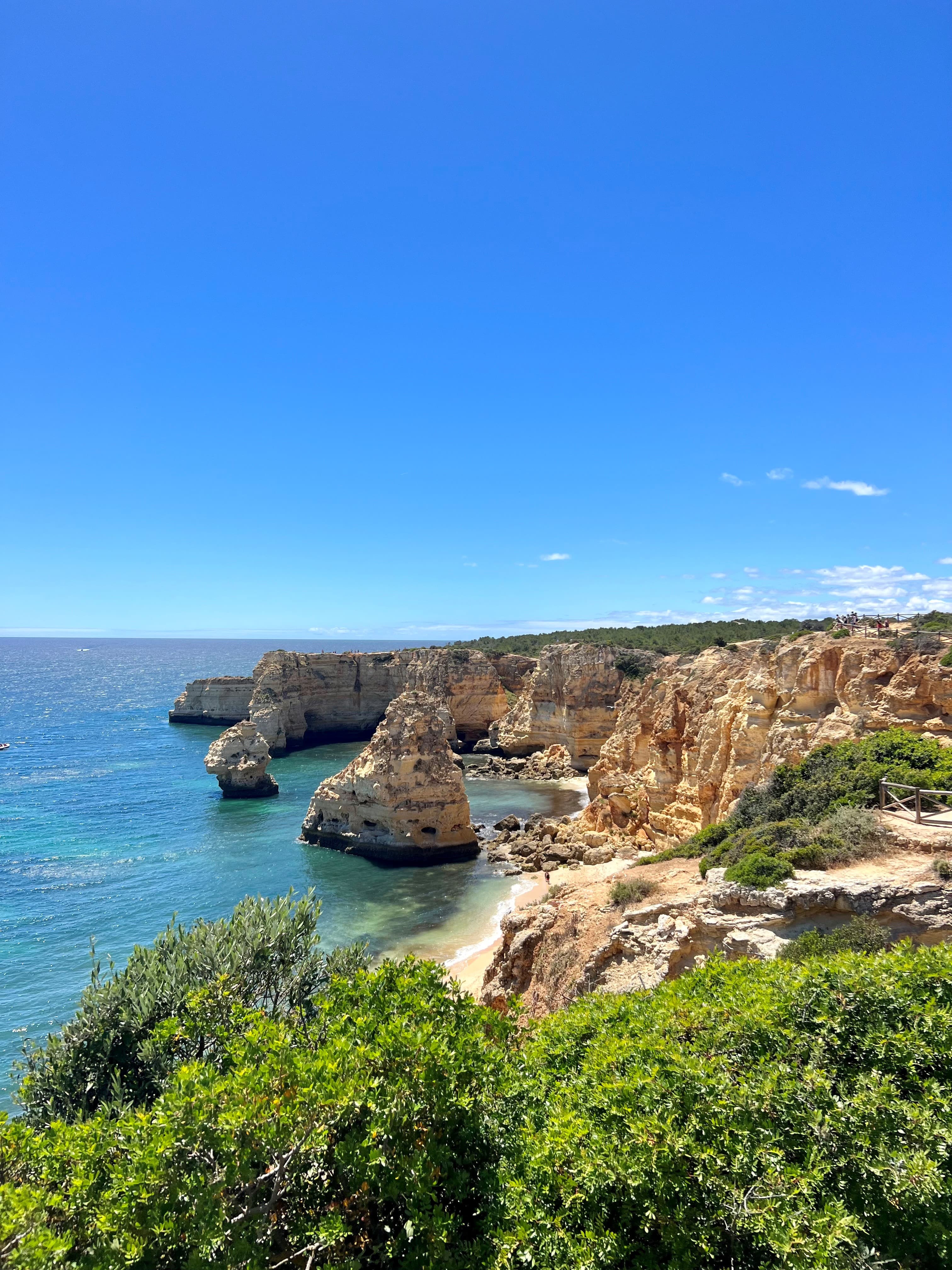 Gorgeous coastal view of steep cliffs and an empty beach on a sunny day