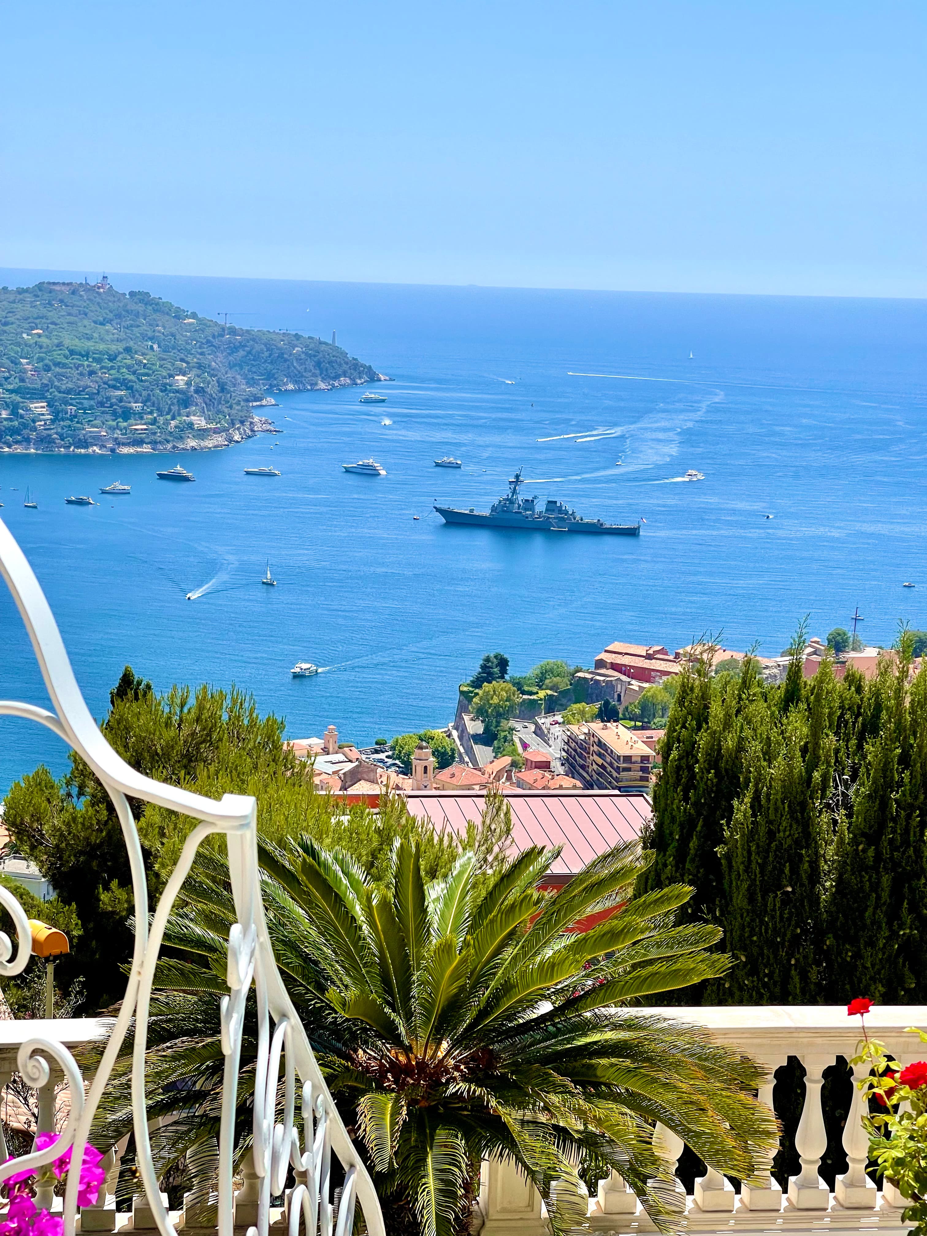 View from a balcony with the ocean in the distance on a sunny day.