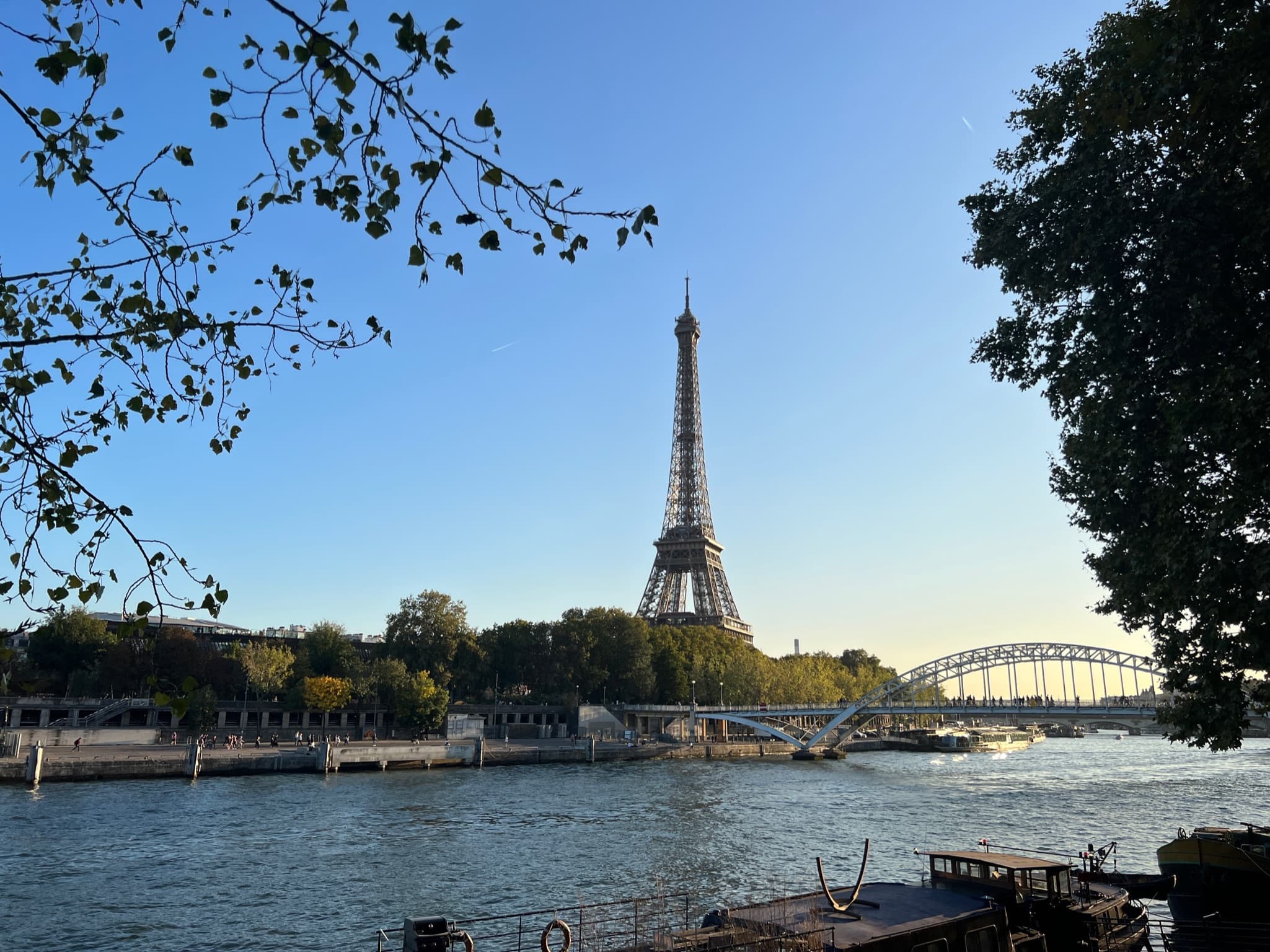 Beautiful view of the Eiffel Tower from across the Seine river at sunset