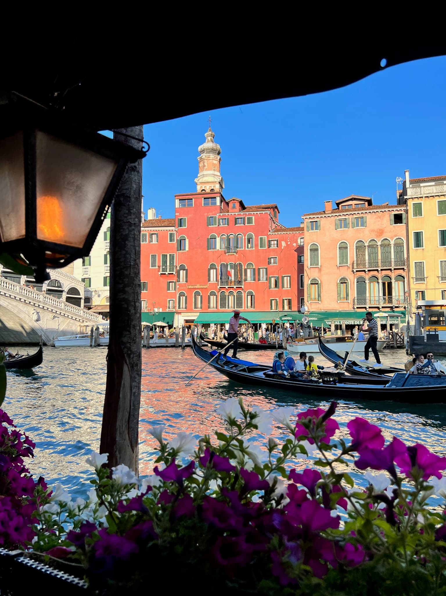 Body of water with boats surrounded by tall buildings.