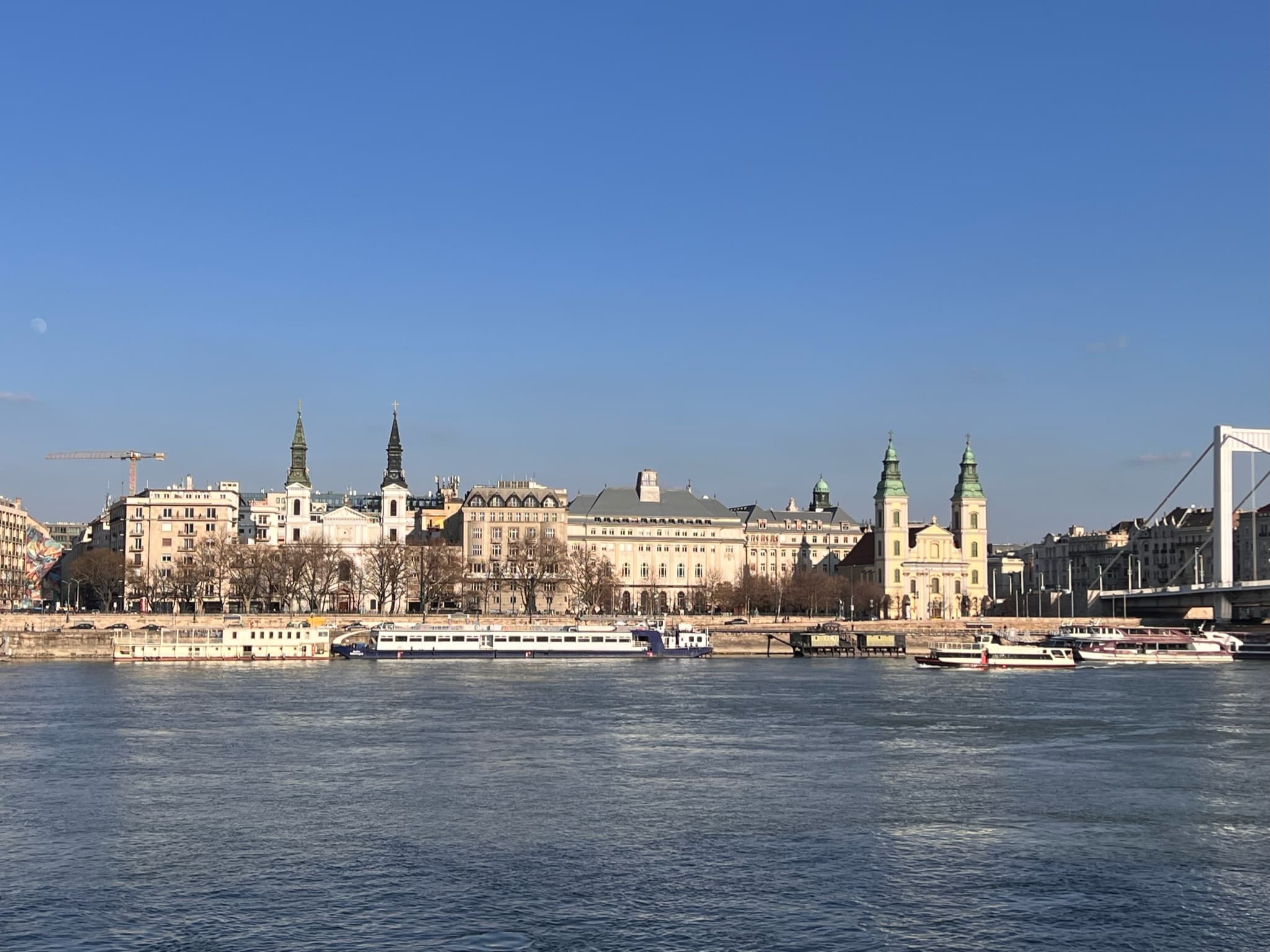 View of a building in the distance surrounded by a body of water.