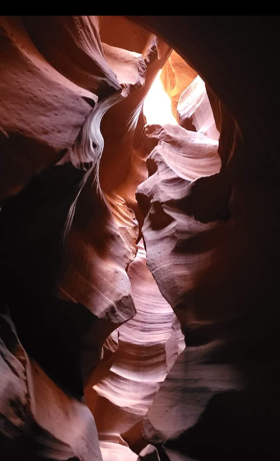 Beautiful image of sunlight coming through a crevice in a red rock formation
