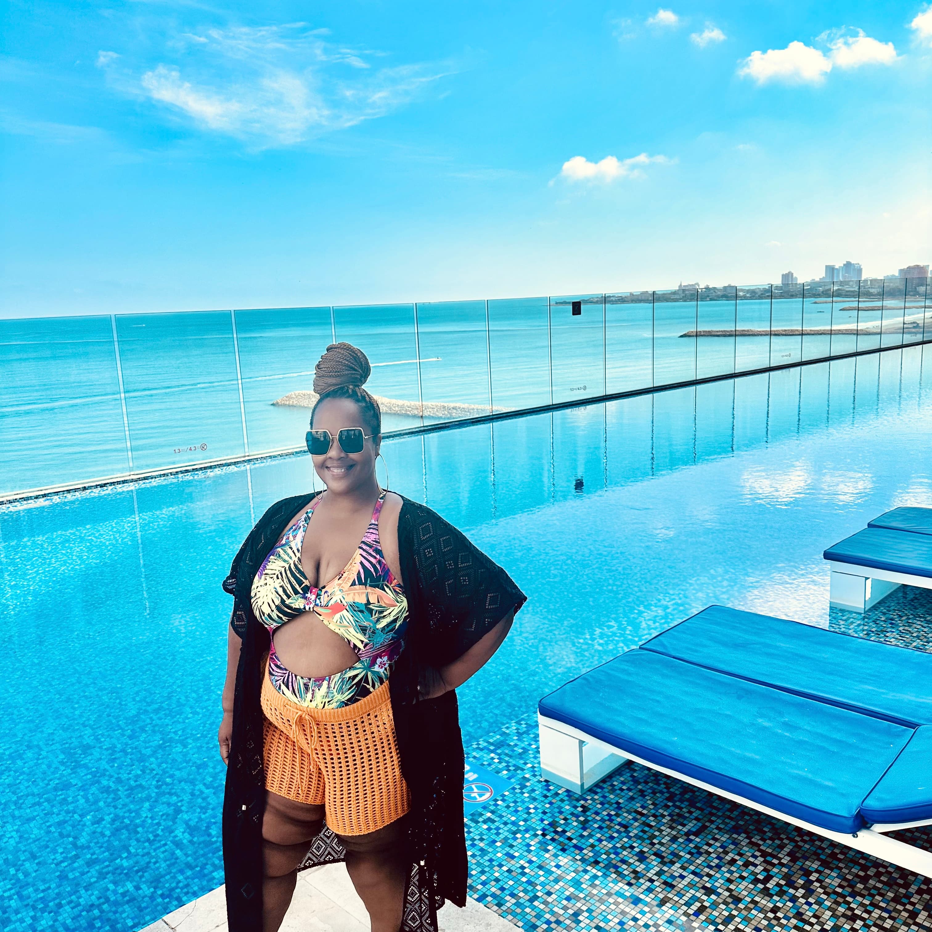 Advisor posing near a pool on a sunny day.