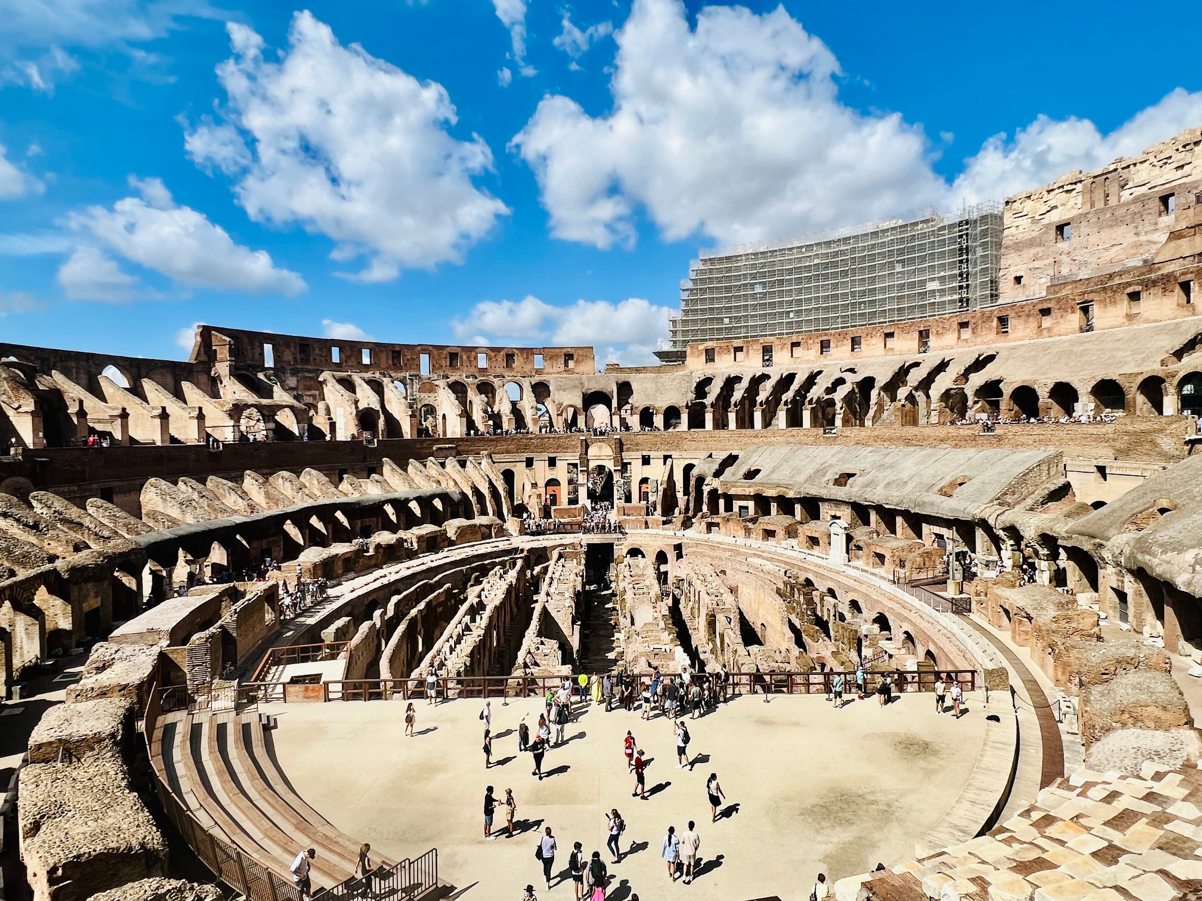 Image of an ancient colosseum during the day.