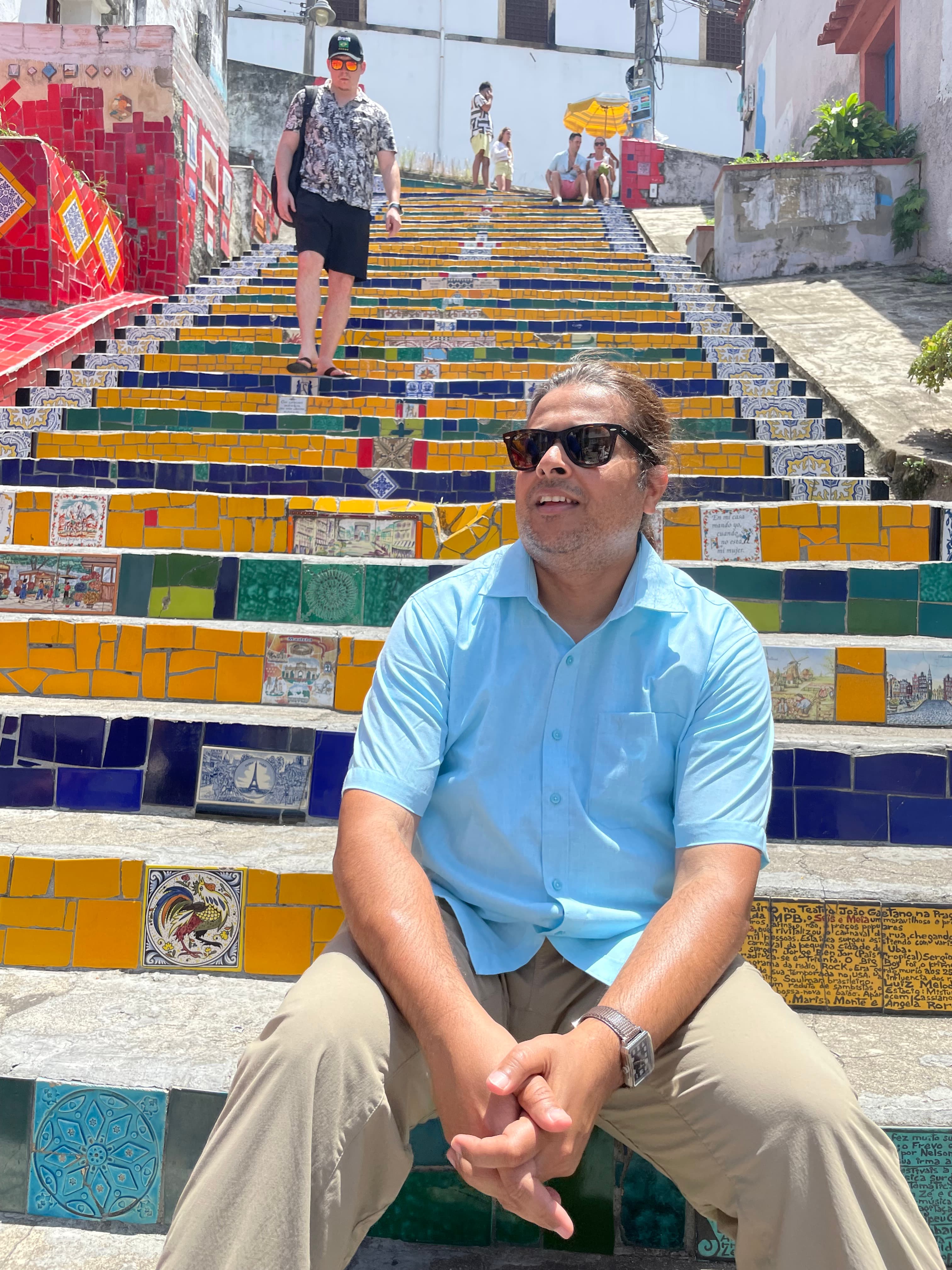 Advisor sitting on a colorful staircase during the day.