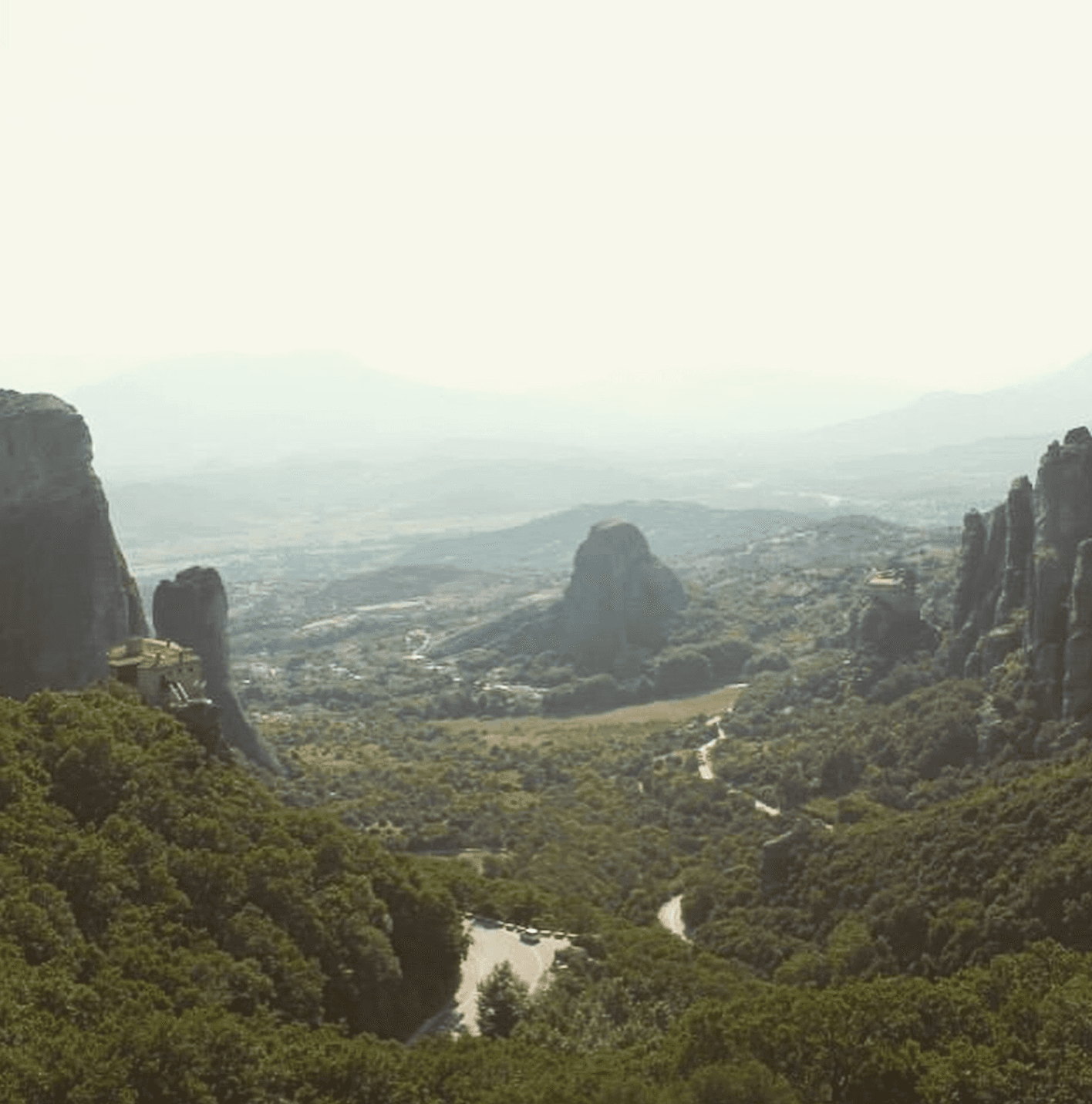 Scenic landscape of mountains and valleys seen from a hilltop.