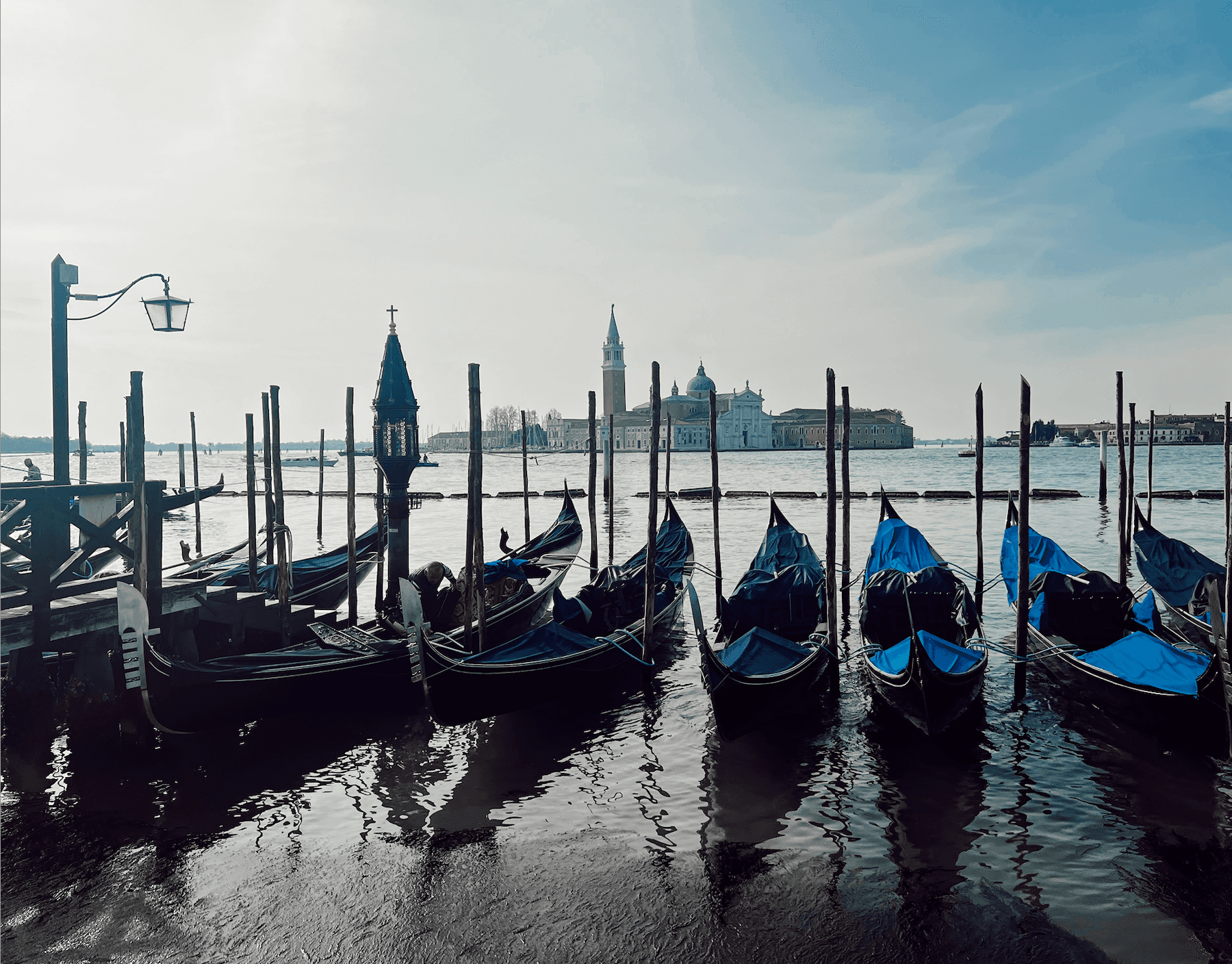 Photo of Gondolas on a canal in the water.