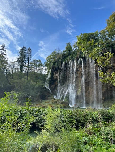 Scenic view of Plitvice Lakes National Park in Croatia with crystal clear turquoise lakes and lush green forests.