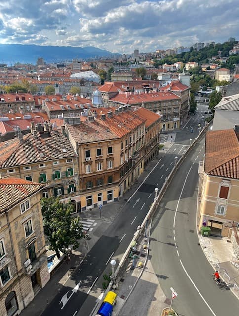 City skyline from rooftop, showing buildings and streets below.