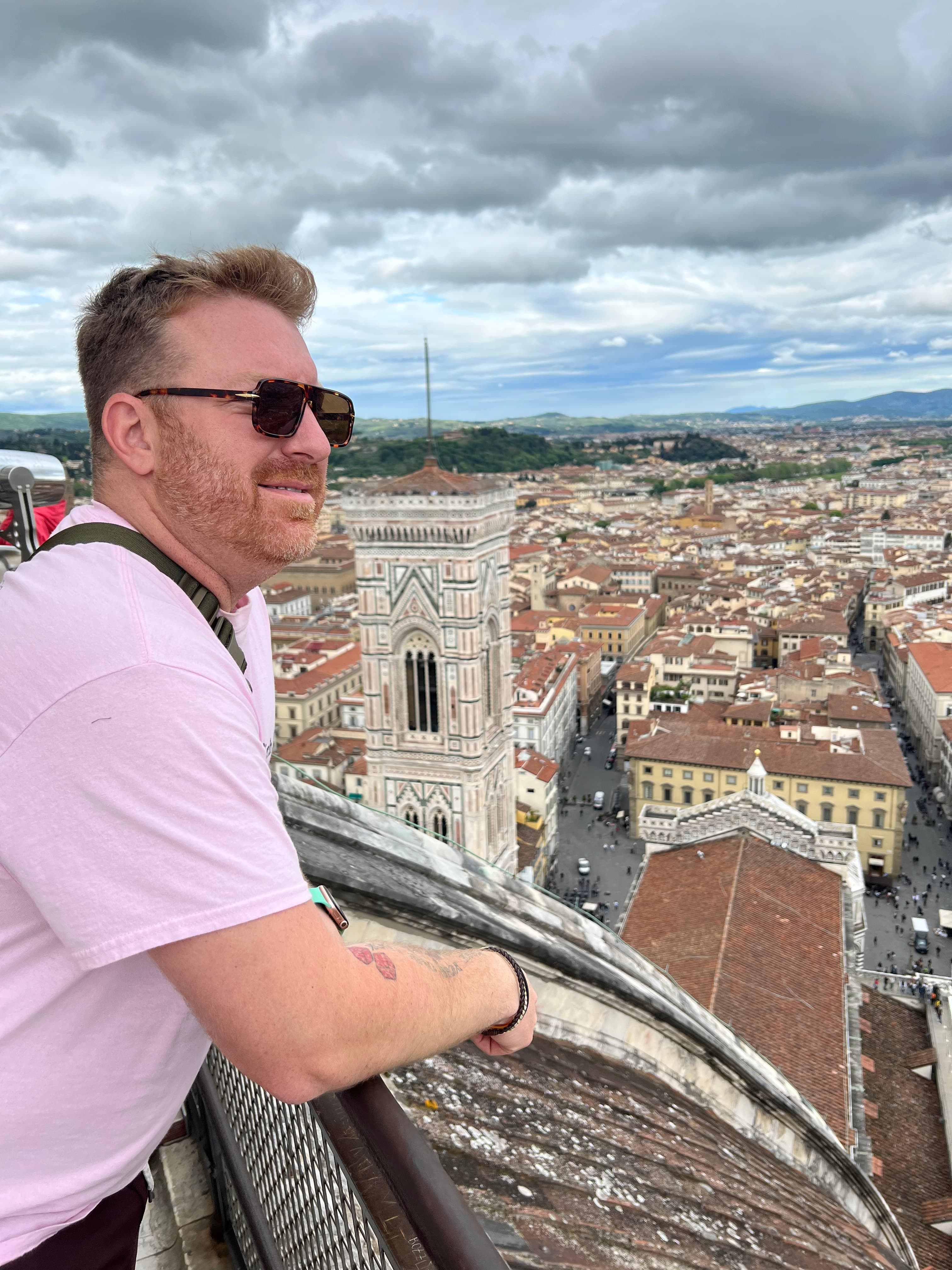 Advisor at a lookout point overlooking a tower and beautiful old cityscape on a cloudy day