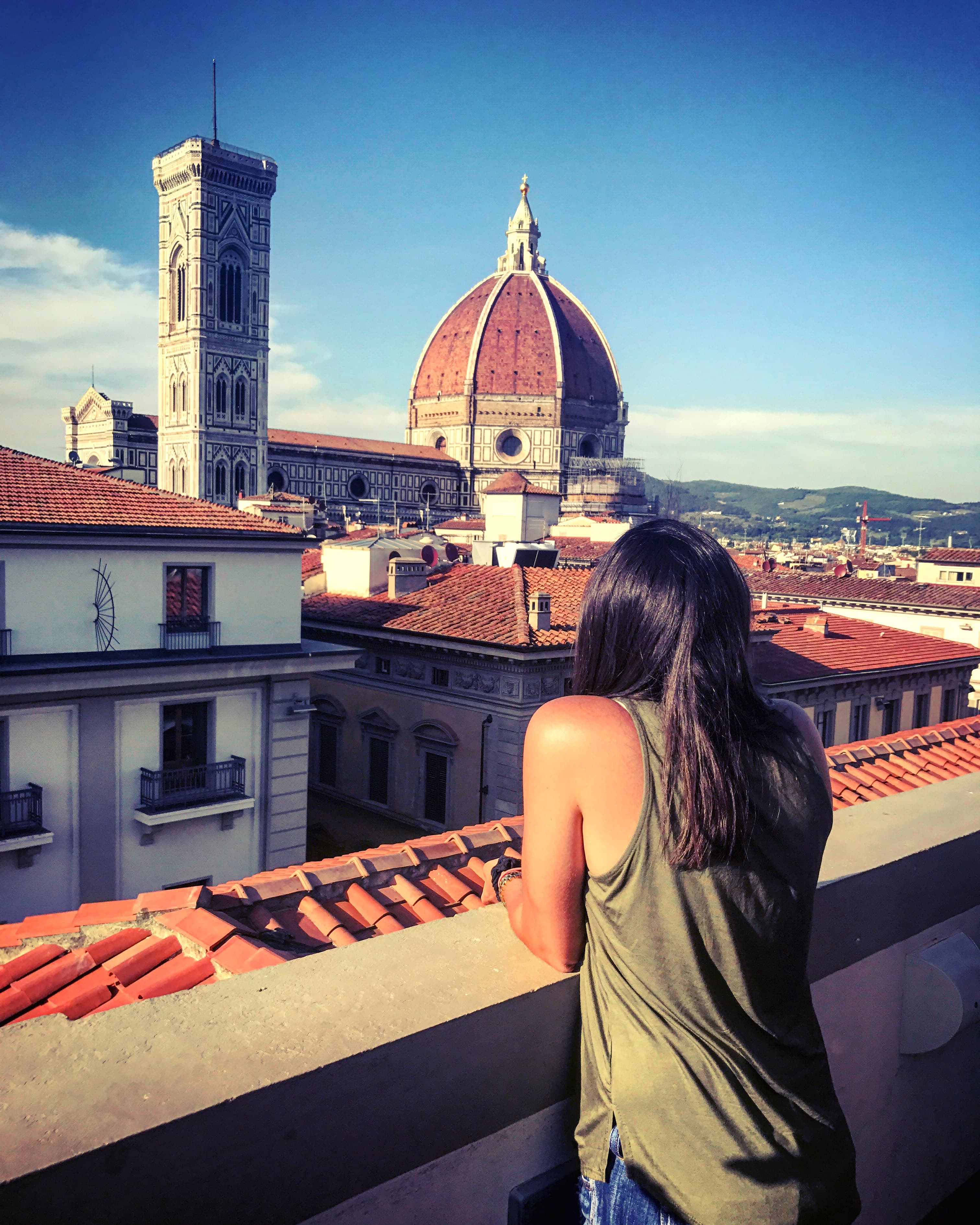 Michelle on a rooftop looking out over the Florence skyline on a sunny day