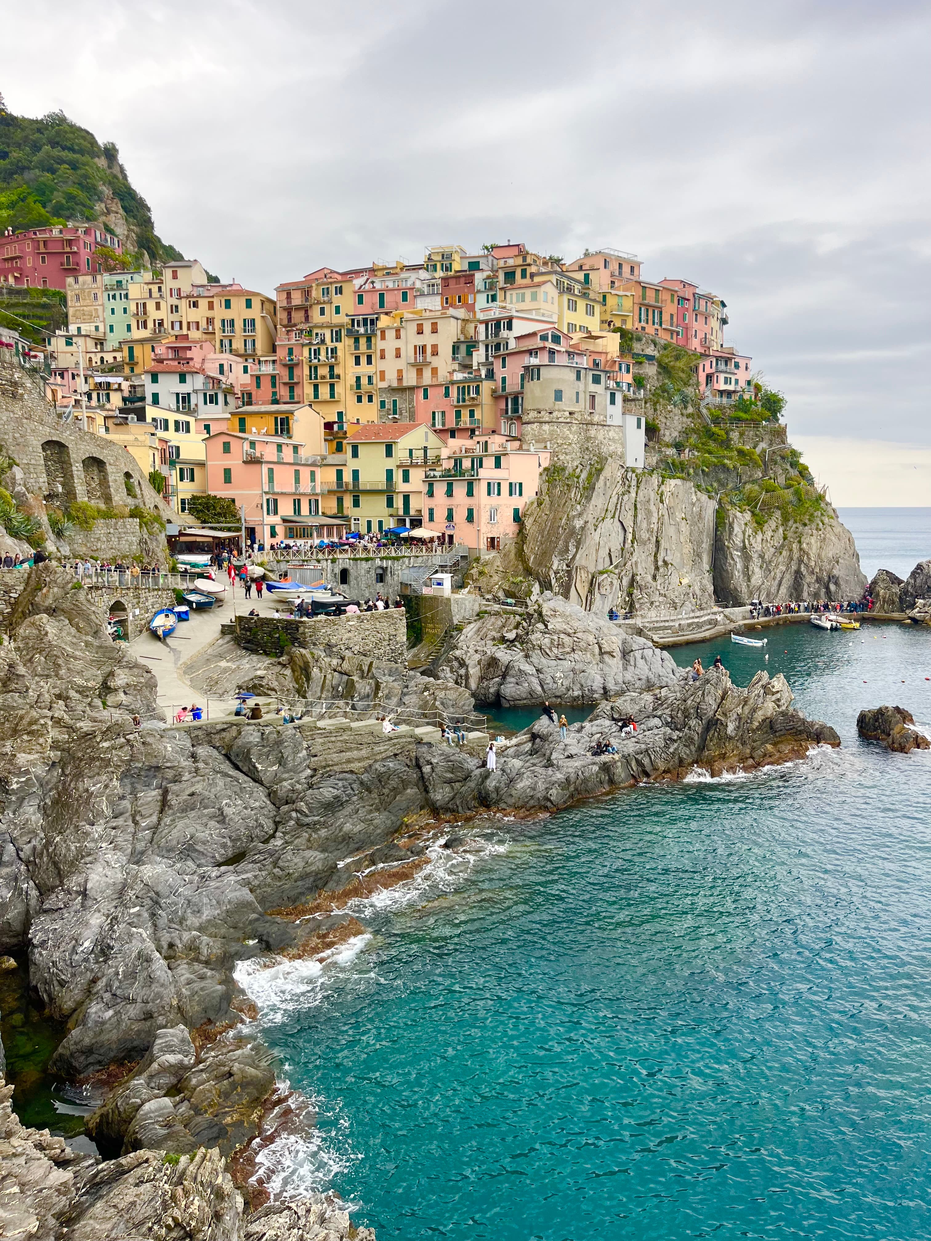 Vibrant houses in Italy overlooking the sea, showcasing a picturesque coastal village.