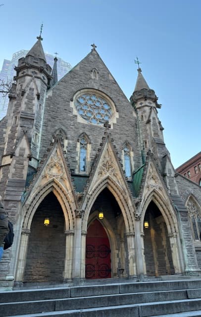 View of a beautiful church with three curved archways in front under clear skies