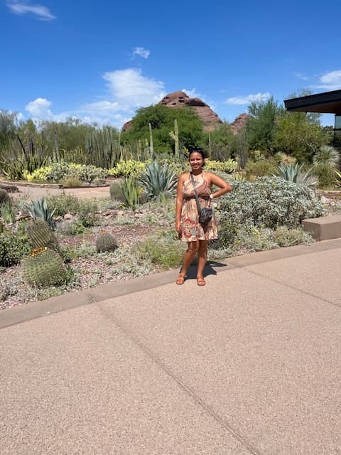 Advisor posing with her hand on her hip outdoors in a desert environment