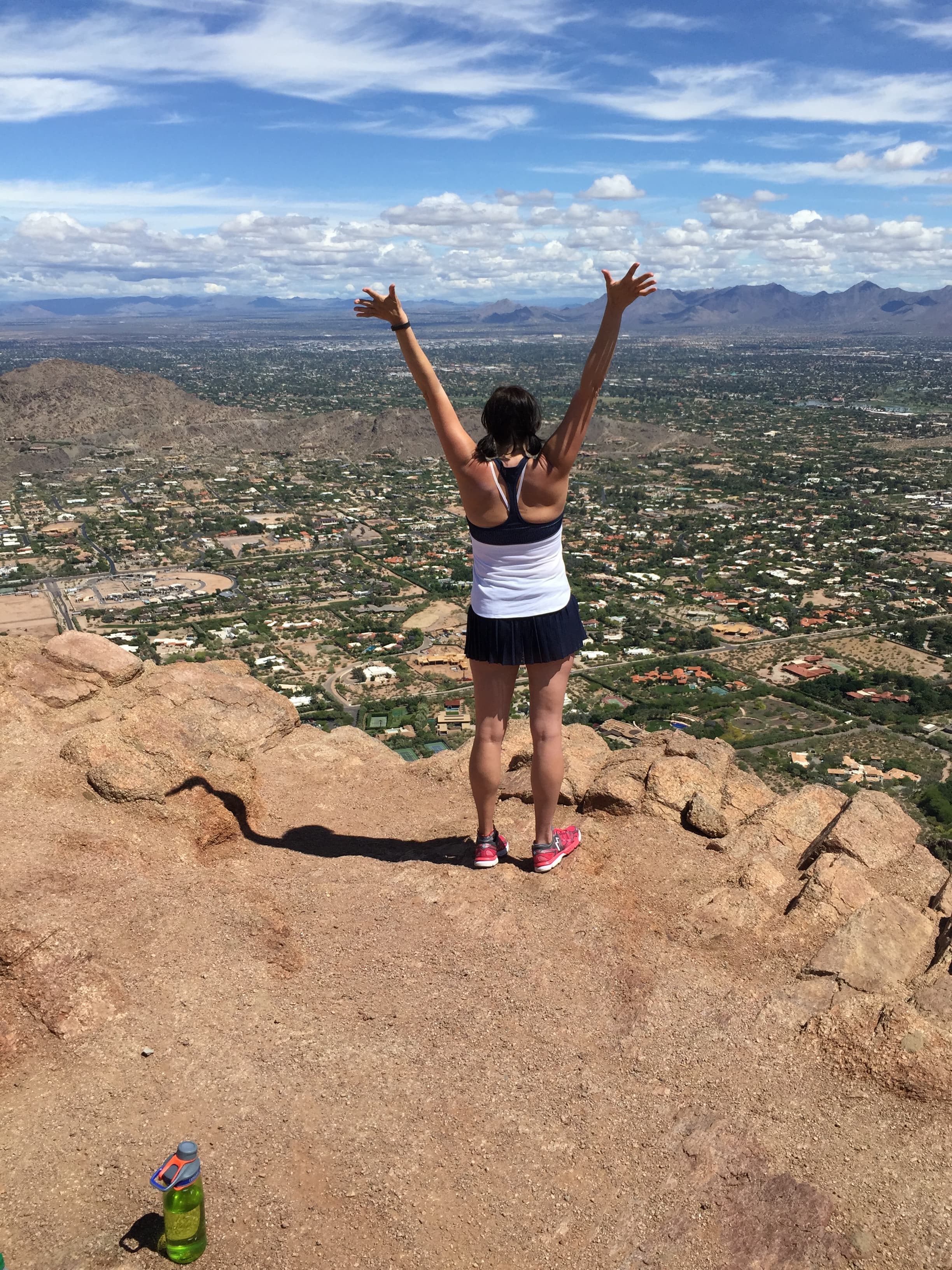 Advisor posing at the top of a mountain hike.