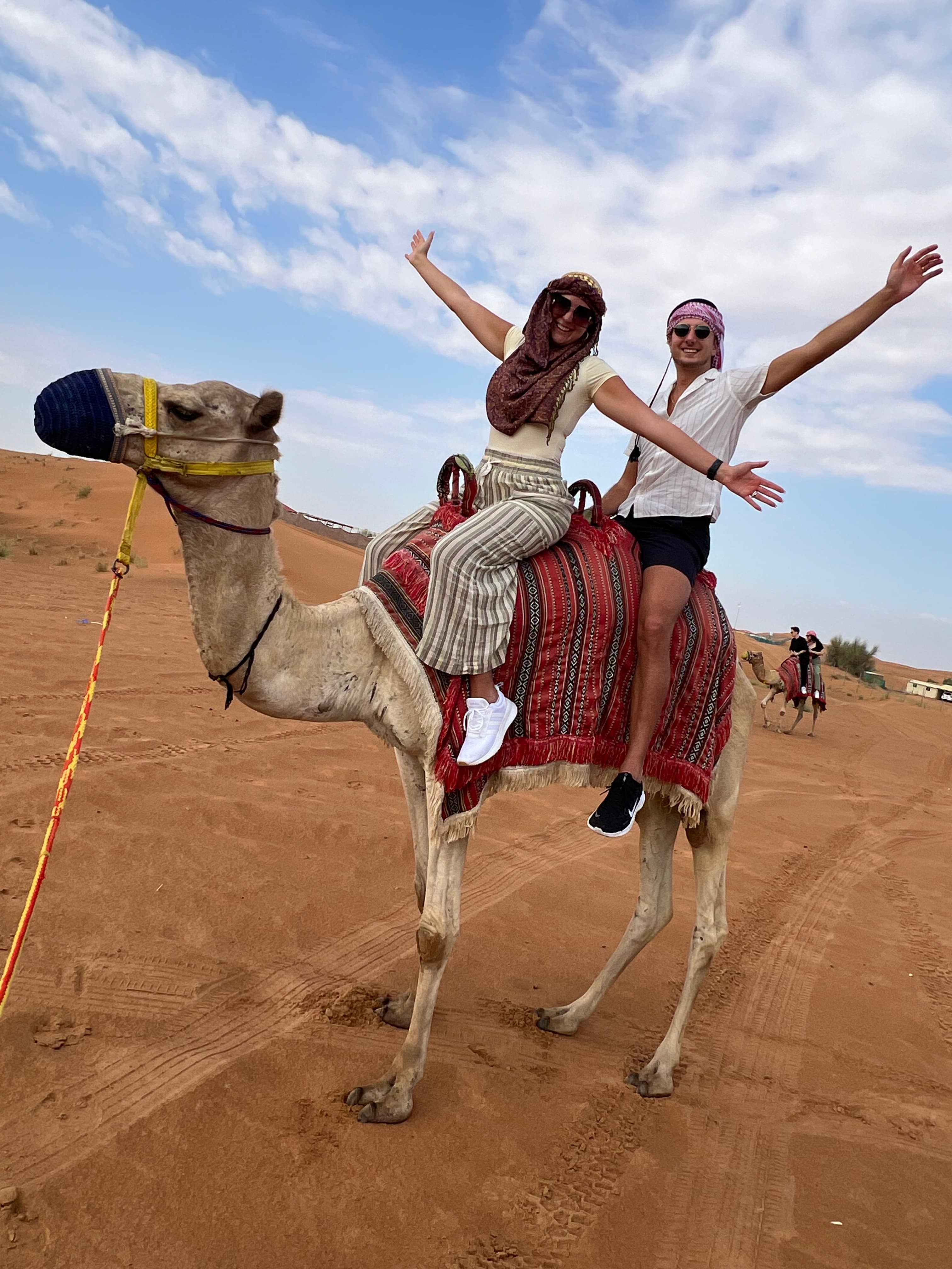 Advisor and a woman on camelback in the desert