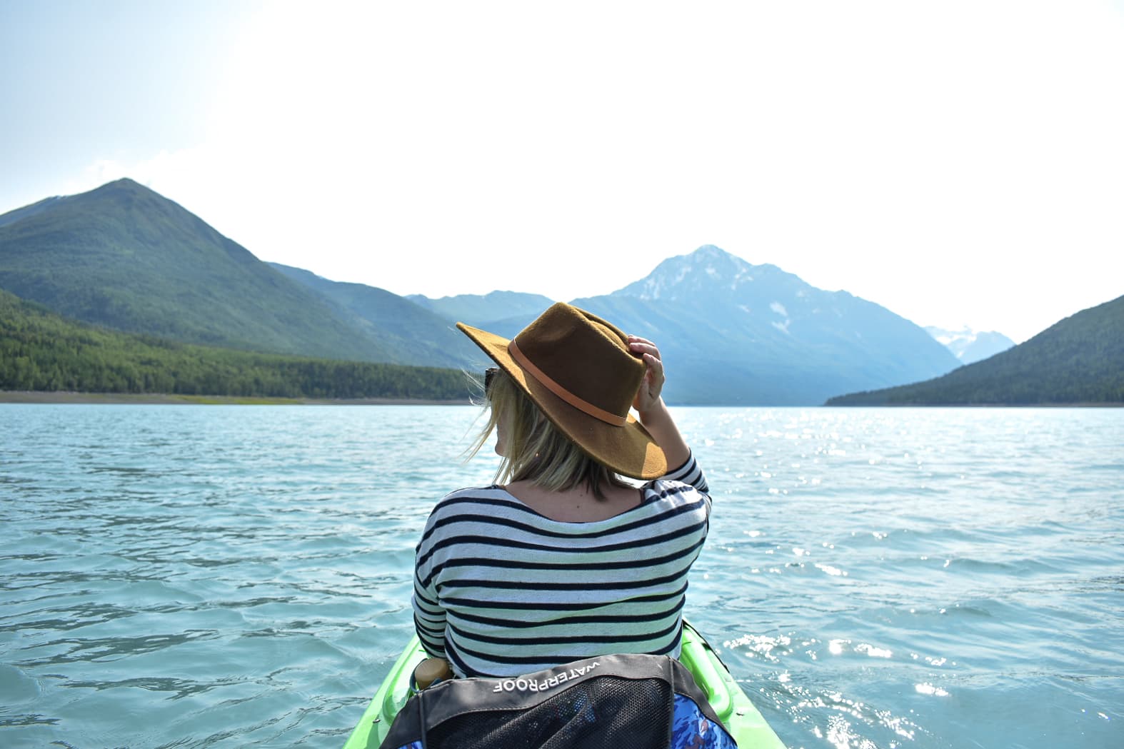 Sitting on a boat with views of mountains.