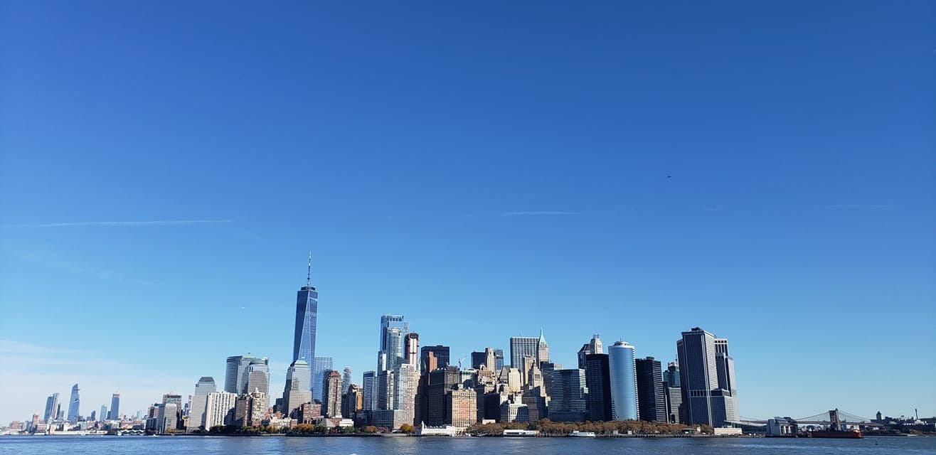 View of tall buildings with a body of water in the foreground.
