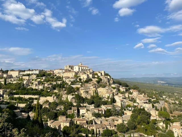 A view of a mountain top town during the day.