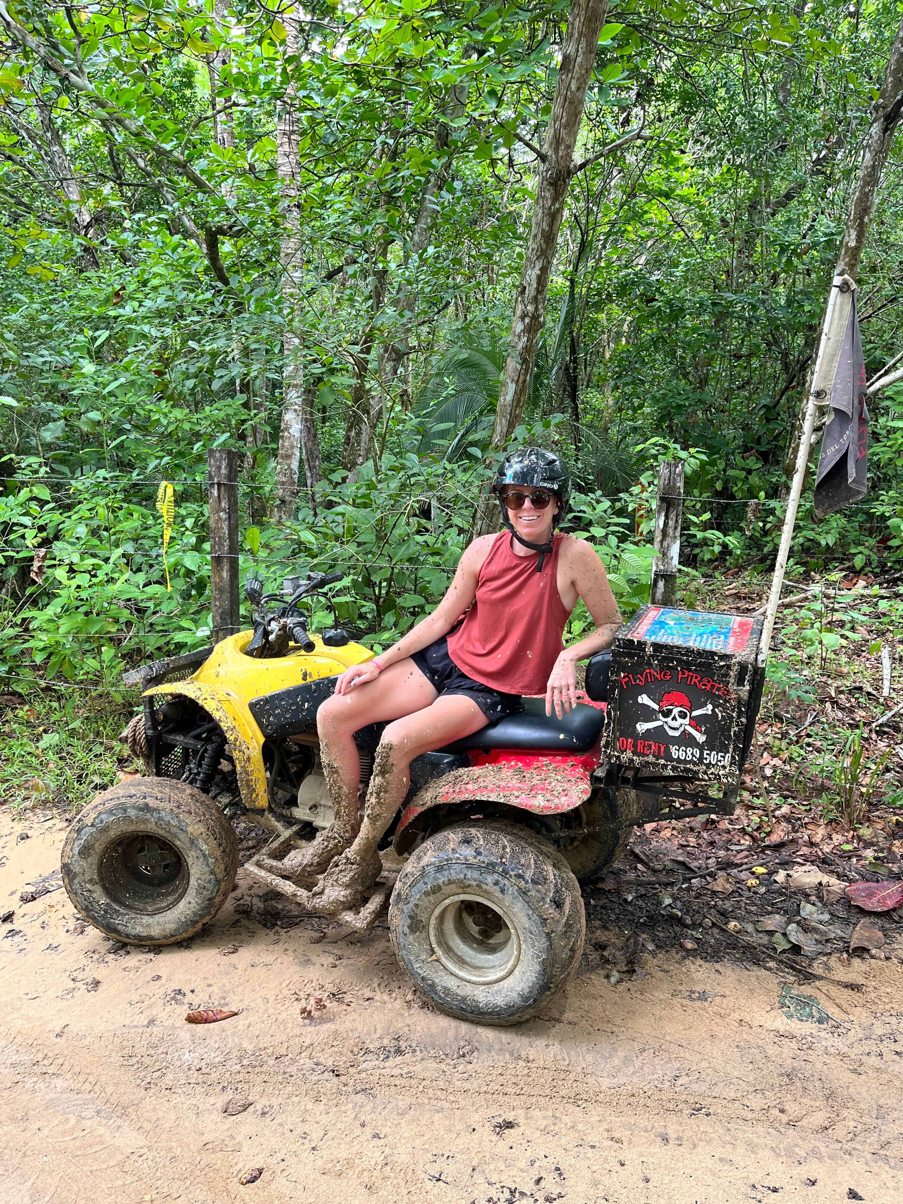 Advisor on a ATV in the jungle during the daytime.