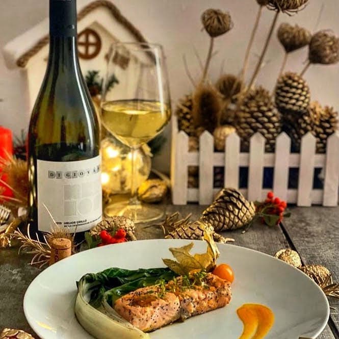 An image of a dinner with wine and pinecones.